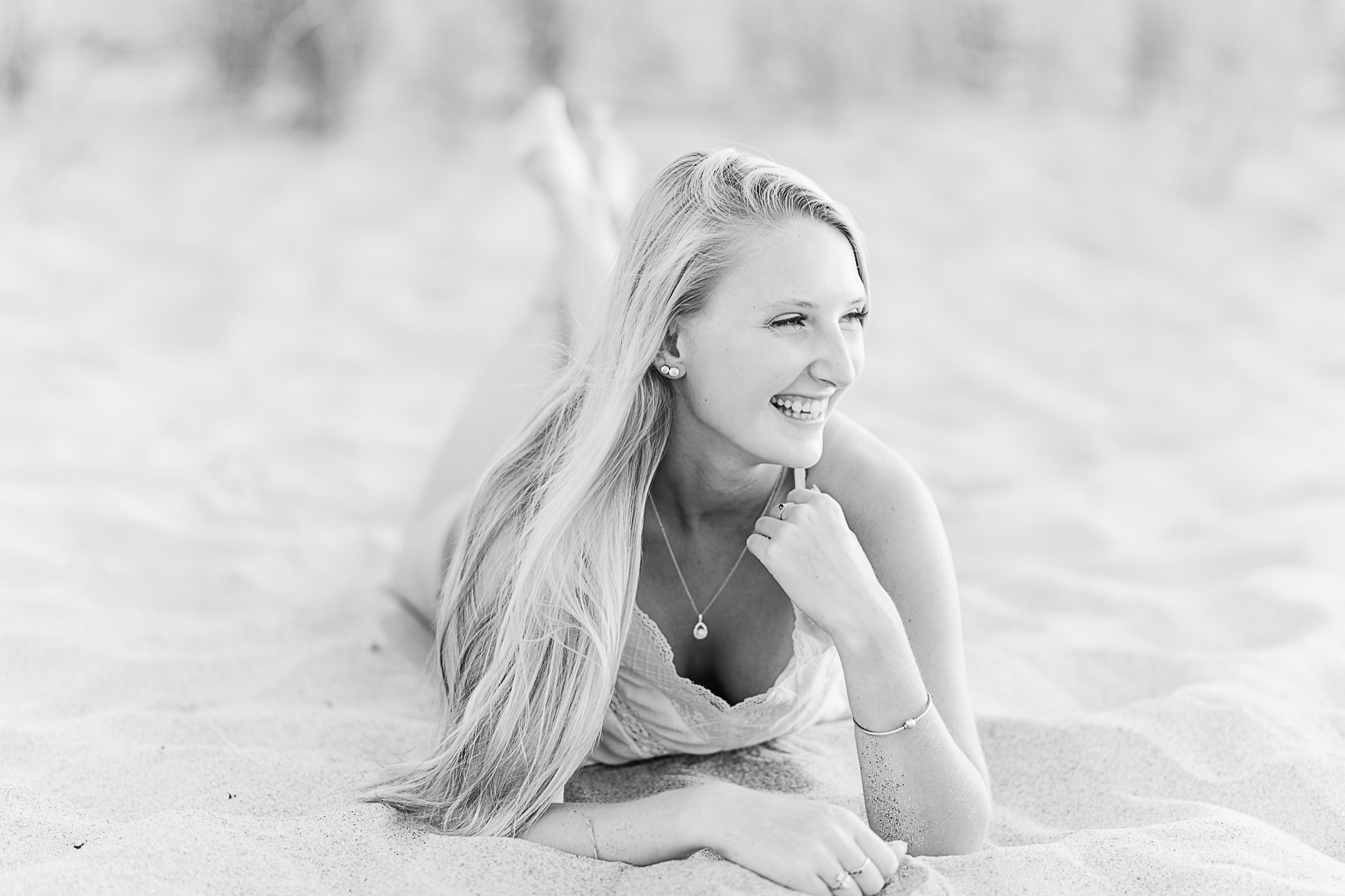 Photo by Cape Cod Senior Portrait Photographer Christina Runnals | High school senior girl laying on her stomach in the sand 