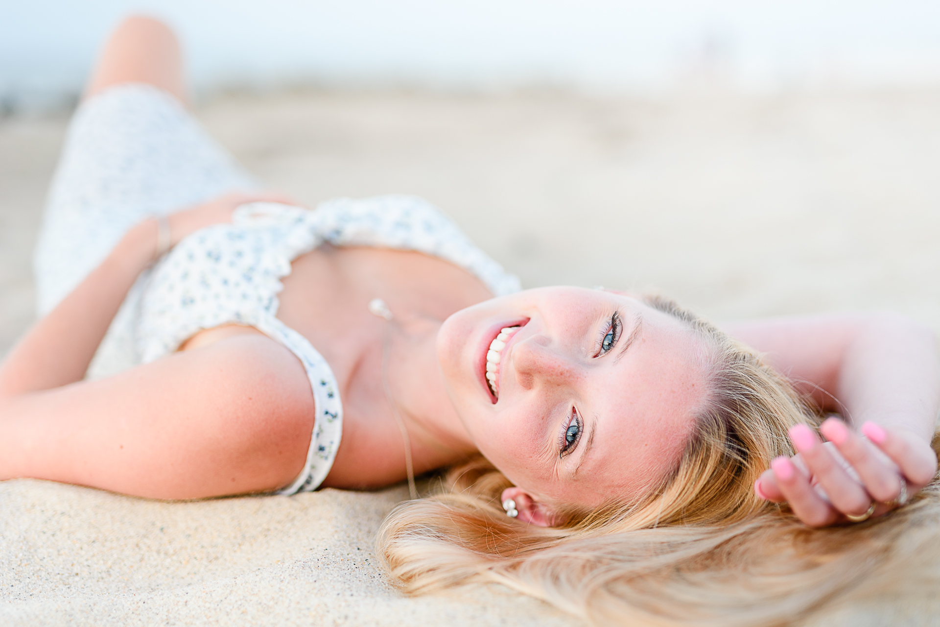 Photo by Cape Cod Senior Portrait Photographer Christina Runnals | High school senior girl laying on her back in the sand 