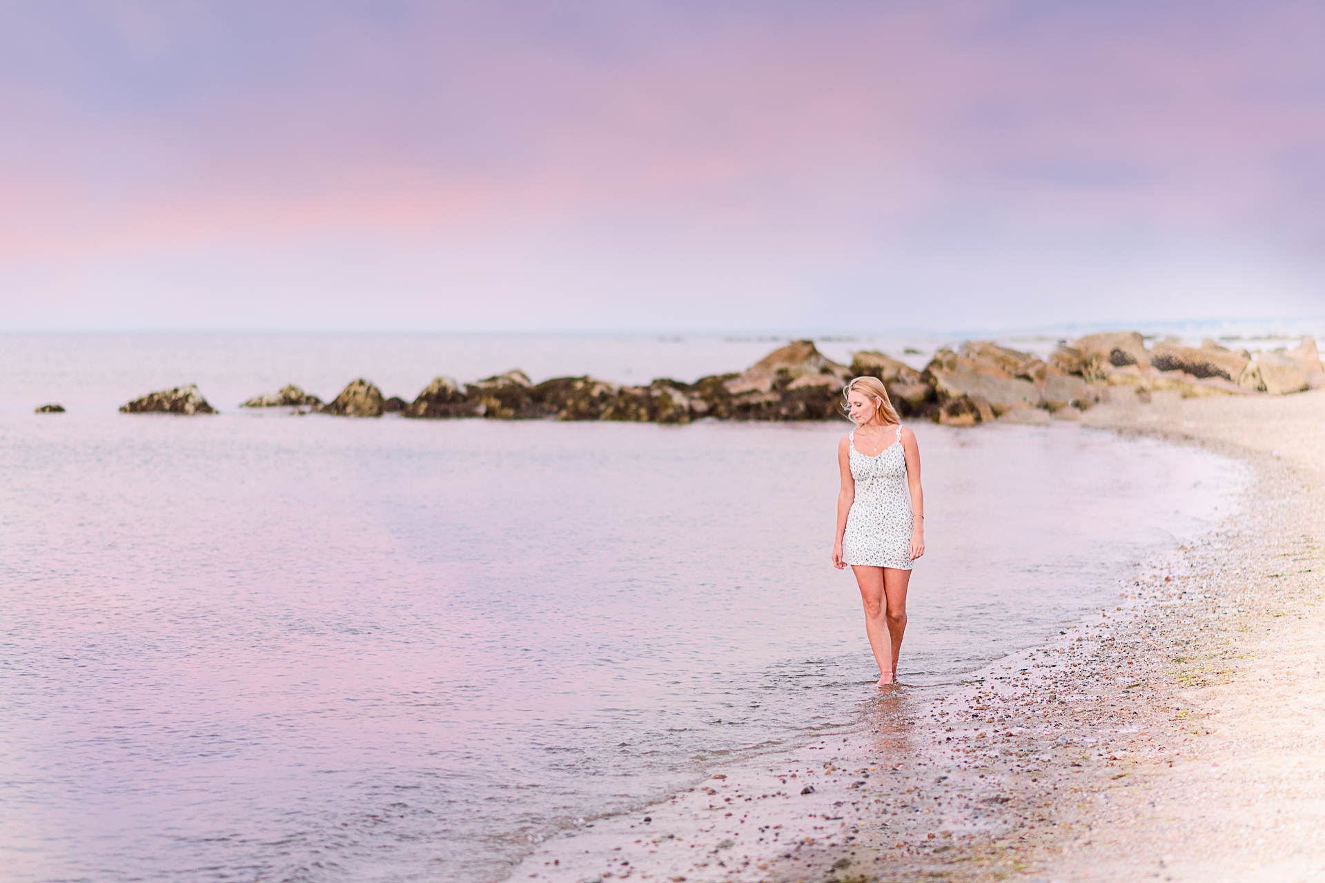 Photo by Cape Cod Senior Portrait Photographer Christina Runnals | High school senior girl walking along the beach in Cape Cod with a a pink sunset in the background