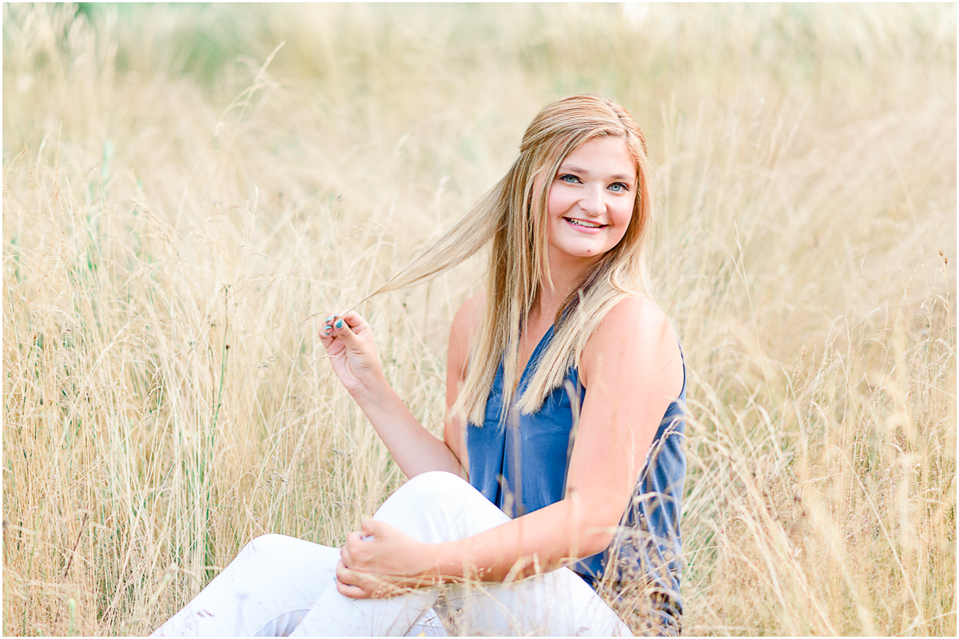 Photo by Marshfield senior portrait photographer Christina Runnals | High school girl sitting in a golden field