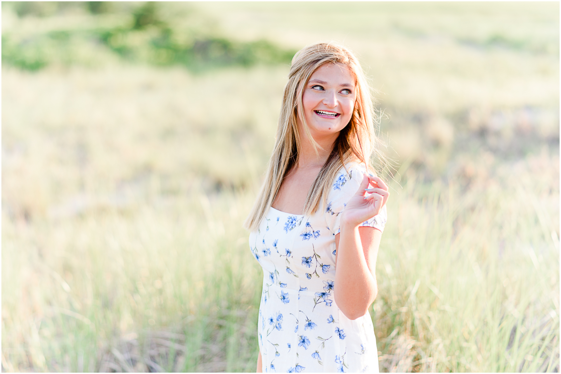Photo by Marshfield senior portrait photographer Christina Runnals | High school girl wearing a white dress and laughing