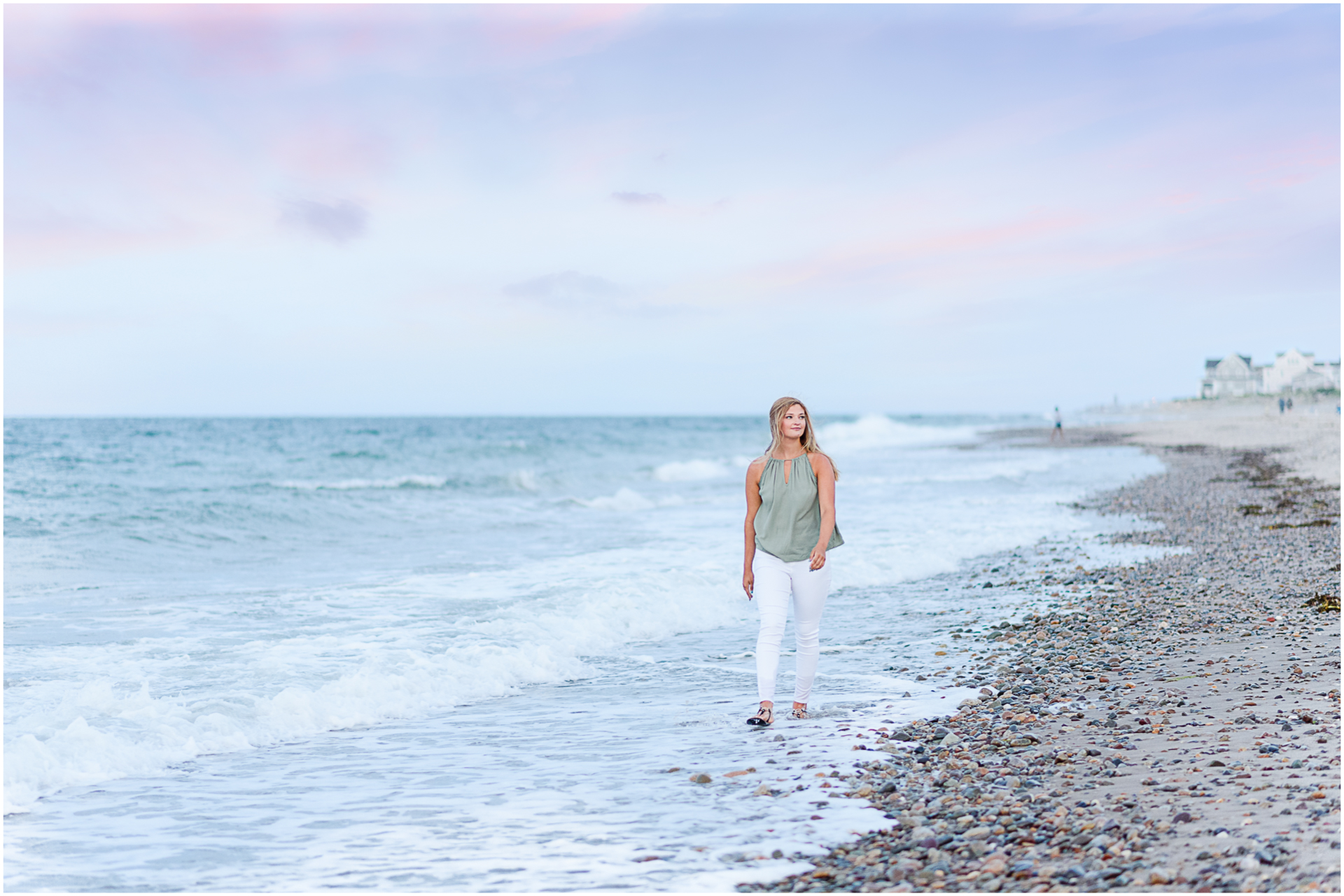 Photo by Marshfield senior portrait photographer Christina Runnals | High school girl walking along the sands of Rexhame beach with a purple and pink sunset in the background
