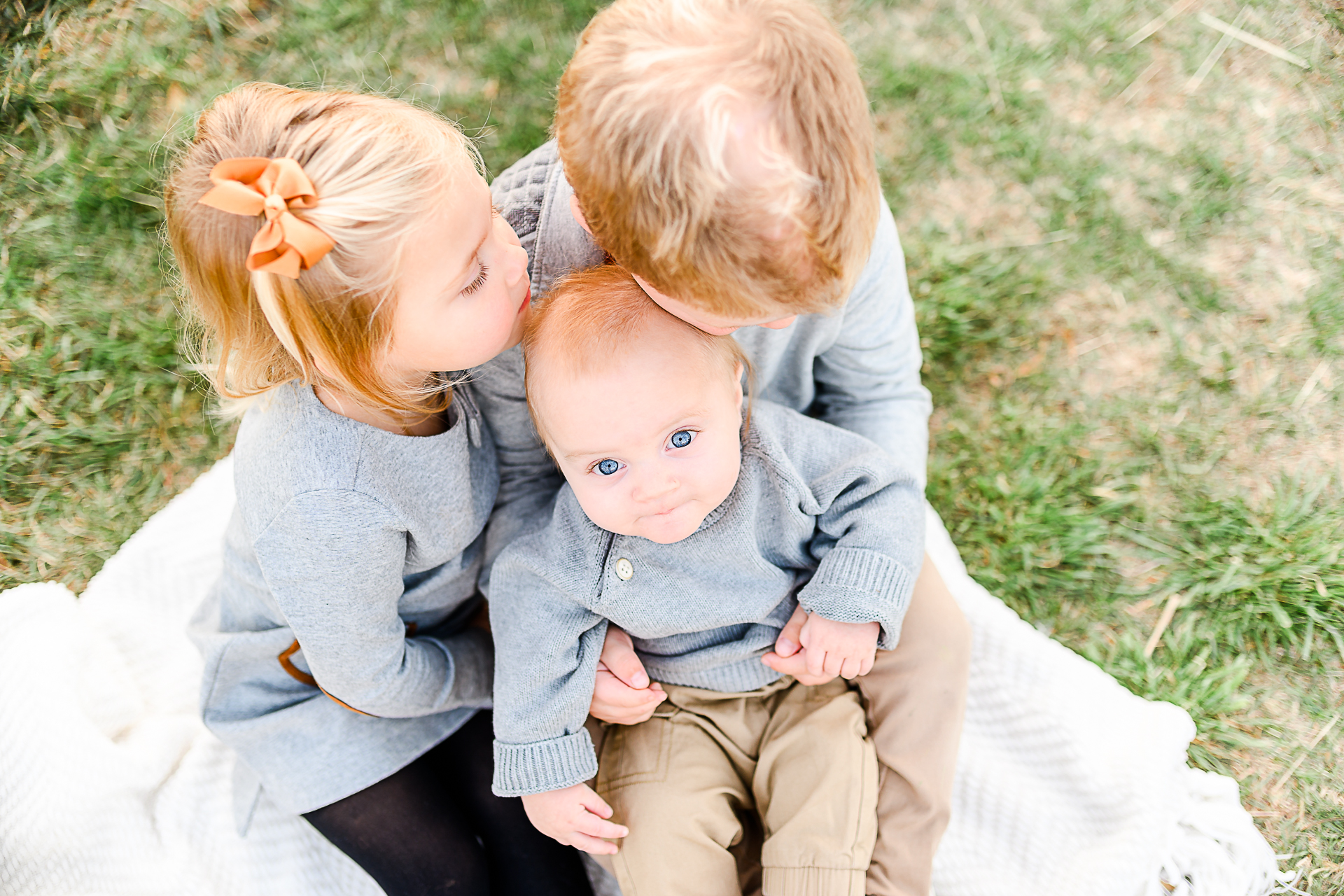 Photo by Norwell Photographer Christina Runnals | Boy and girl holding their baby brother