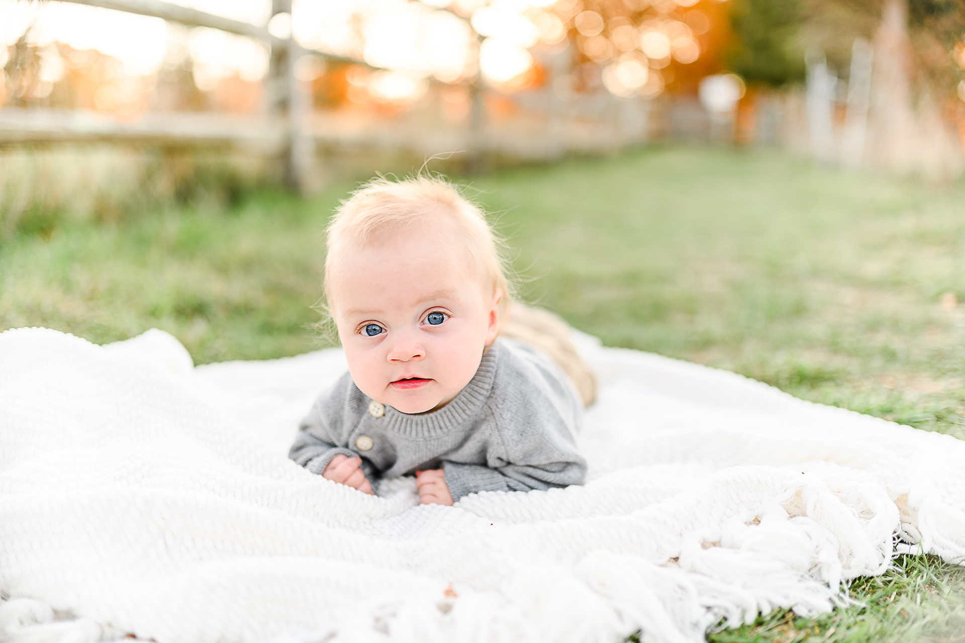 Photo by Norwell Photographer Christina Runnals | Baby laying on a white blanket in the grass