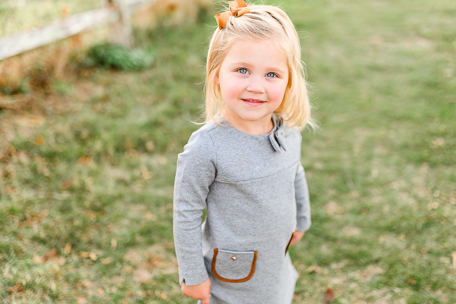 Photo by Norwell Photographer Christina Runnals | Little girl with blue eyes and an orange bow