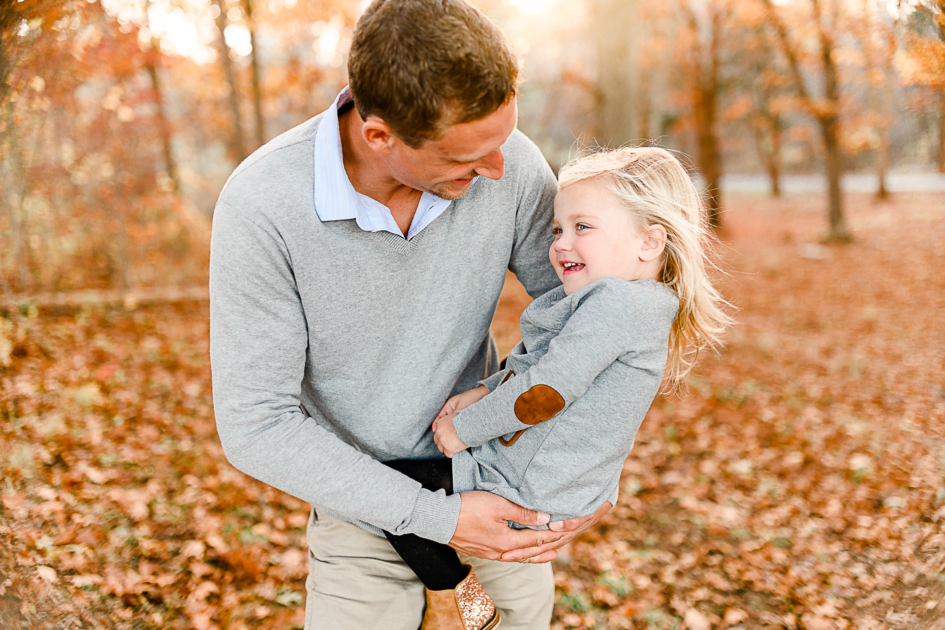 Photo by Norwell Photographer Christina Runnals | dad in an autumn forest spinning his daughter around
