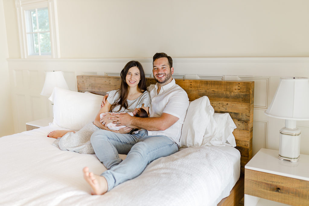 Newborn and parents in bed
