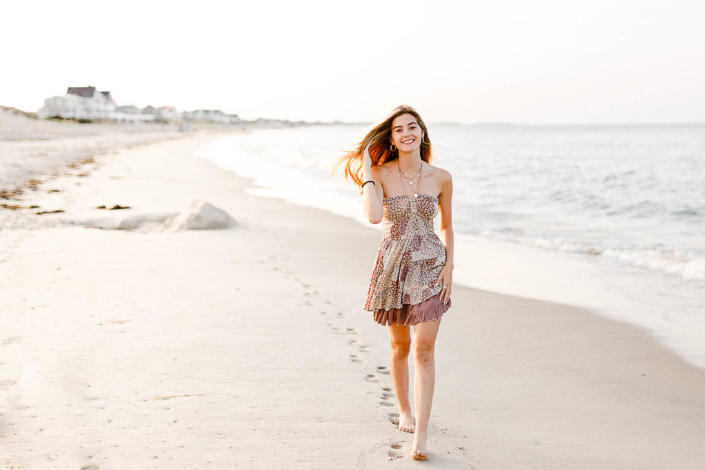 Photo by Cohasset senior portrait photographer Christina Runnals | High school senior girl walking on the beach in a short dress