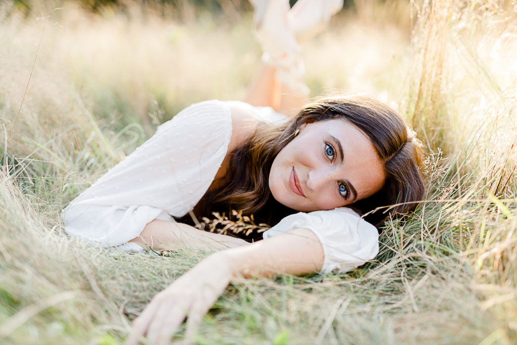 Photo taken by Massachusetts senior photographer Christina Runnals | | High school senior girl laying in a field