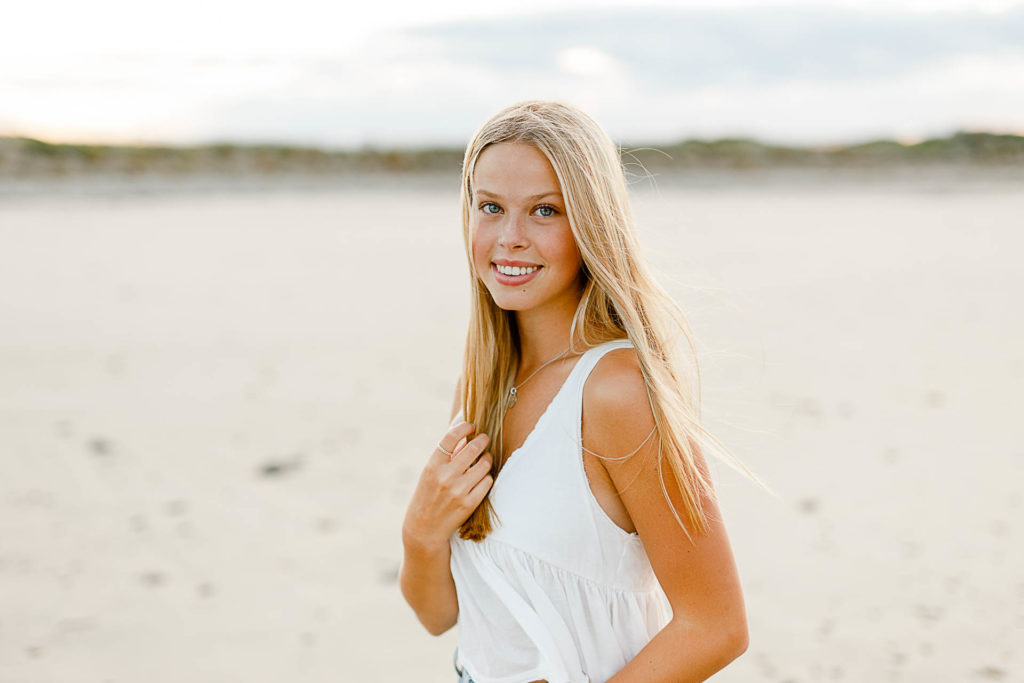 Massachusetts Beach Senior Pictures by Photo by Massachusetts senior portrait photographer Christina Runnals | High school aged girl standing on the beach smiling for her senior portrait pictures