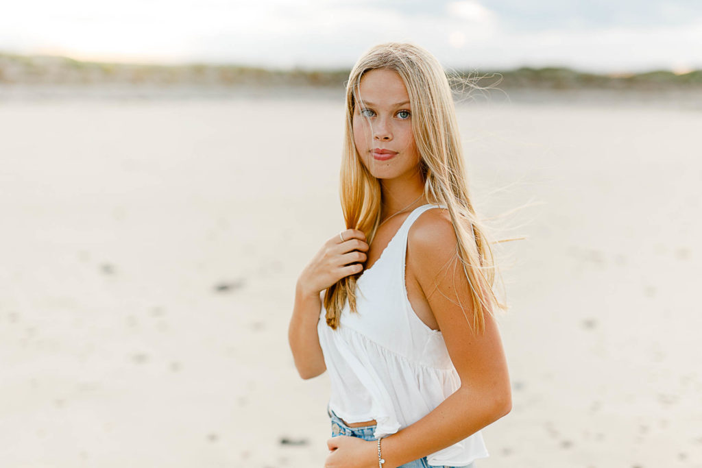 Massachusetts Beach Senior Pictures by Photo by Massachusetts senior portrait photographer Christina Runnals | High school aged girl standing on the beach smiling for her senior portrait pictures
