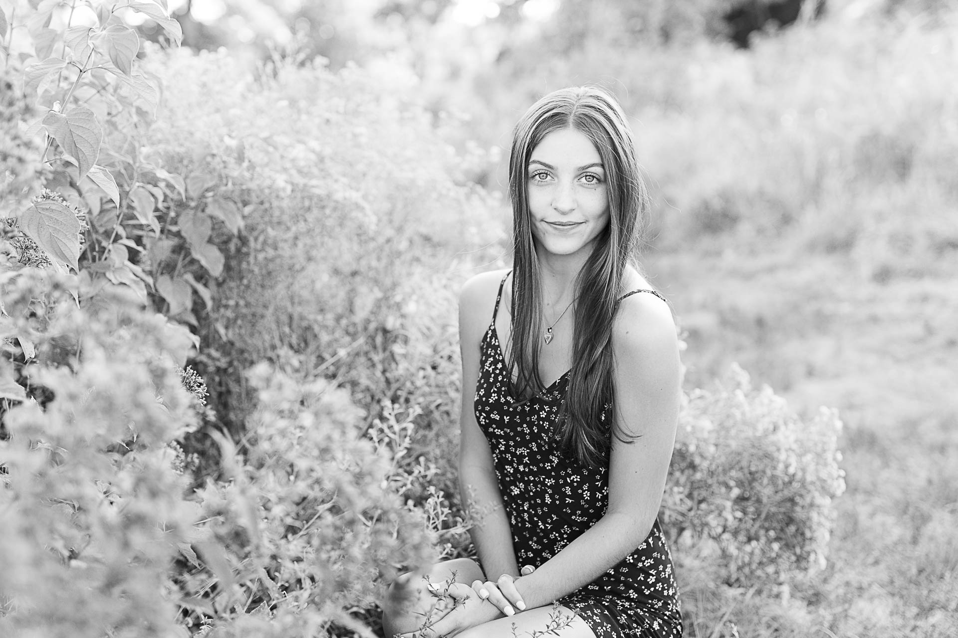Photo by Boston Senior Photographer Christina Runnals | High school senior girl sitting in a wildflower field