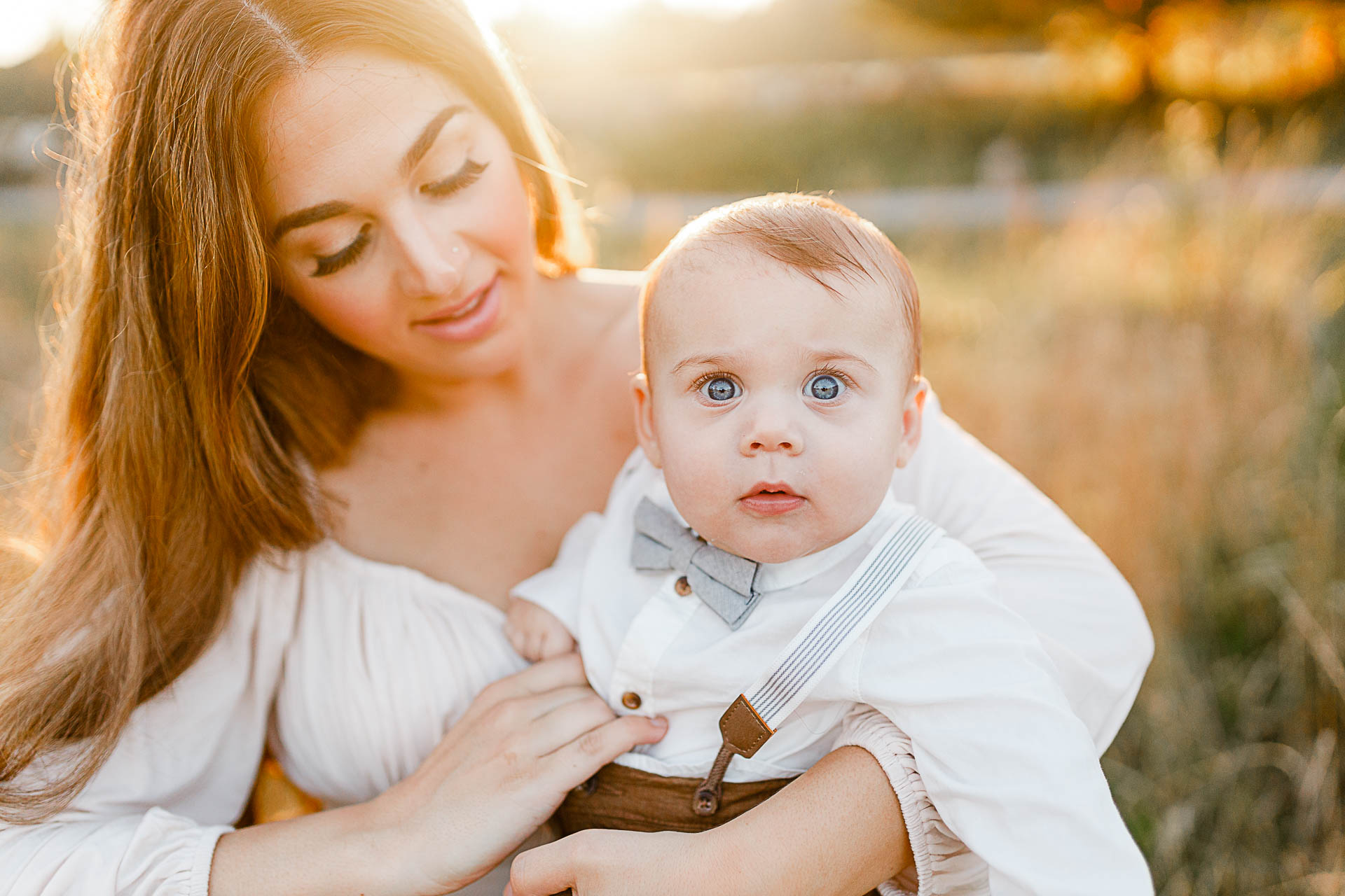 Scituate photographer captures little boy being held by mom in glowing sunset