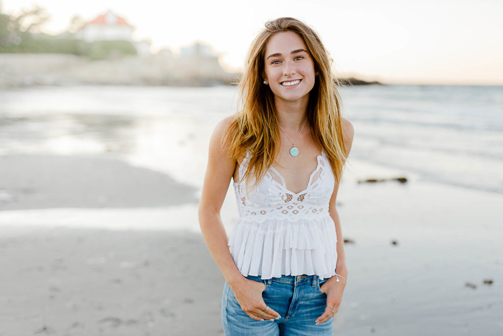 Cohasset Sandy Beach Senior Pictures by Christina Runnals | A high school senior girl standing in front of the ocean at Sandy Beach in Cohasset
