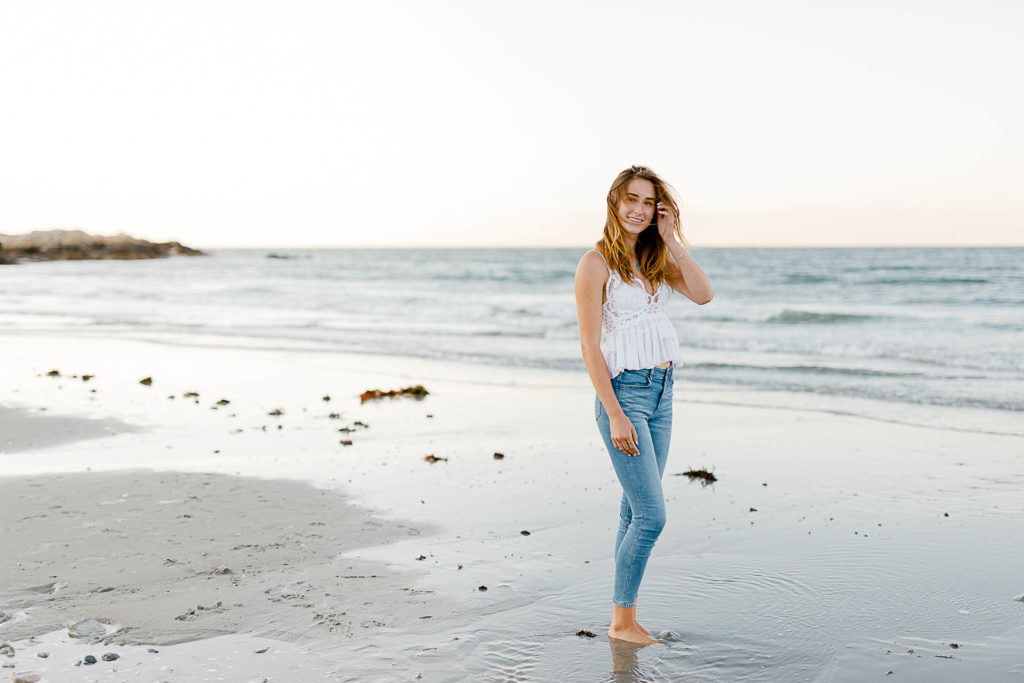 Cohasset Sandy Beach Senior Pictures by Cohasset senior portrait photographer Christina Runnals | A high school senior girl standing in front of the ocean at Sandy Beach in Cohasset