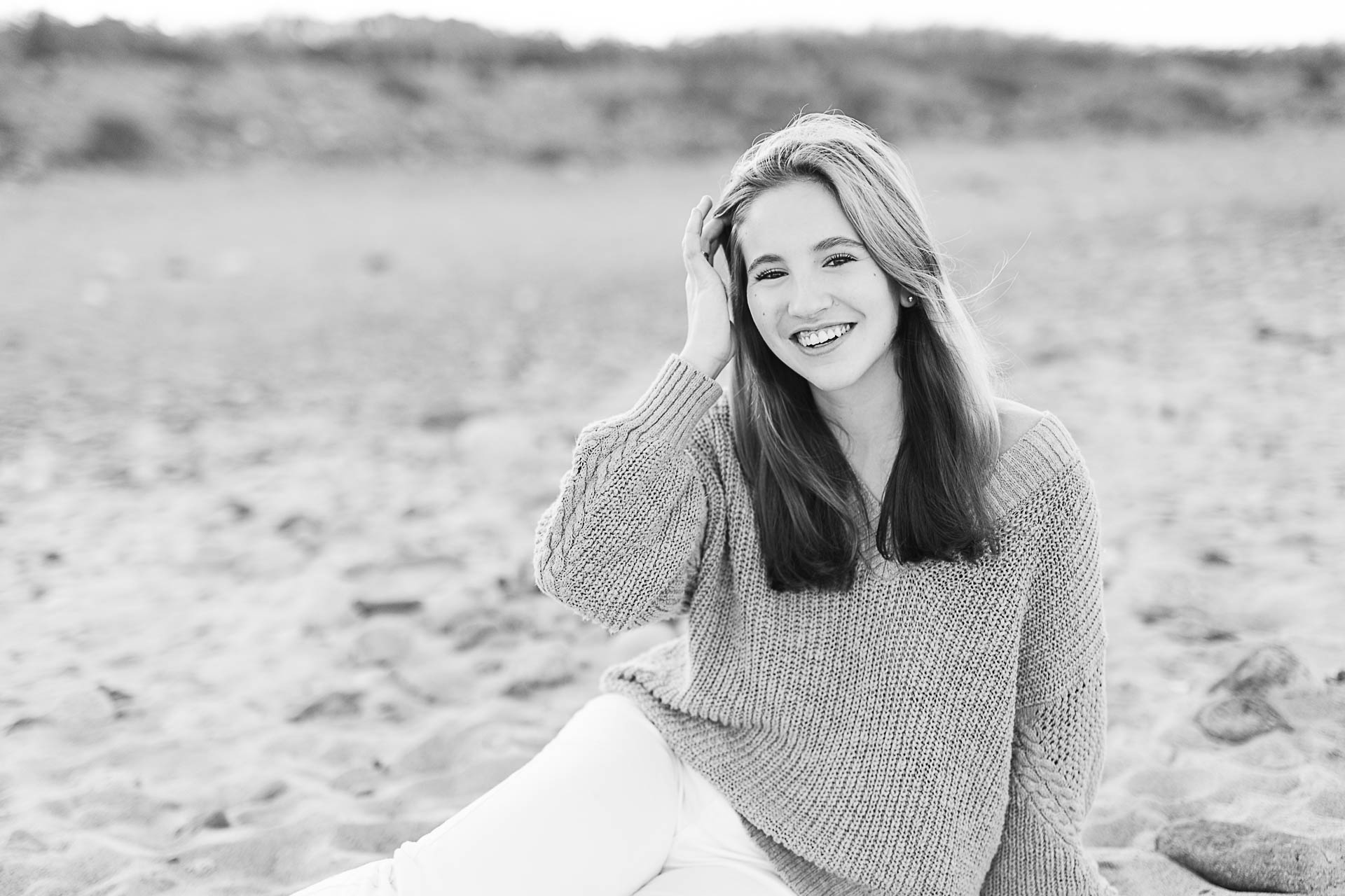 Photo by Cohasset senior photographer Christina Runnals | High school senior girl laying on the sand at a Cohasset beach 