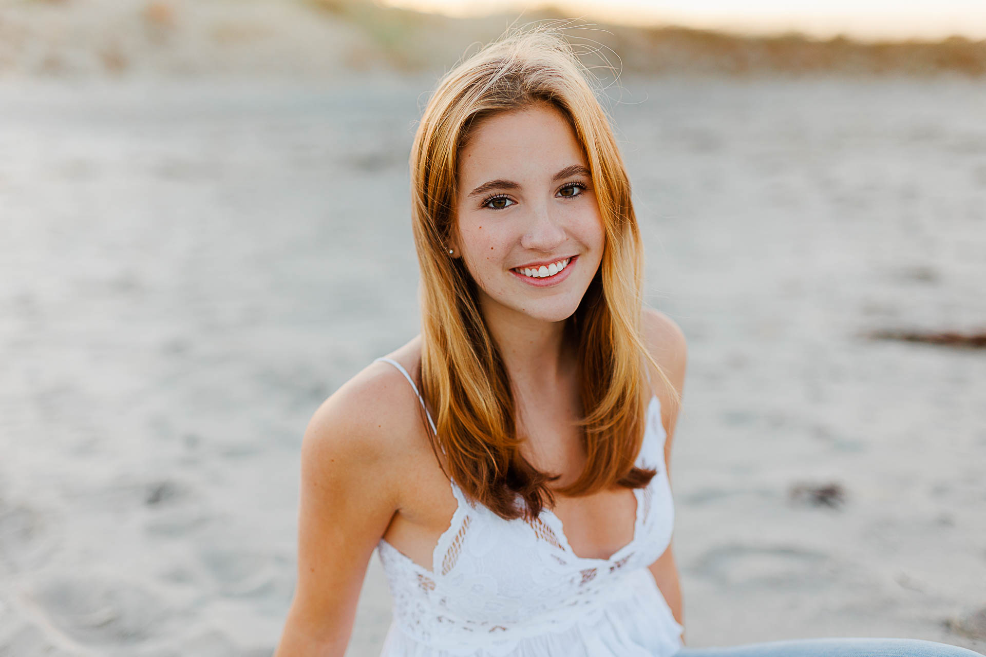 Cohasset senior portraits by Christina Runnals Photography | Girl sitting in the sand at golden hour