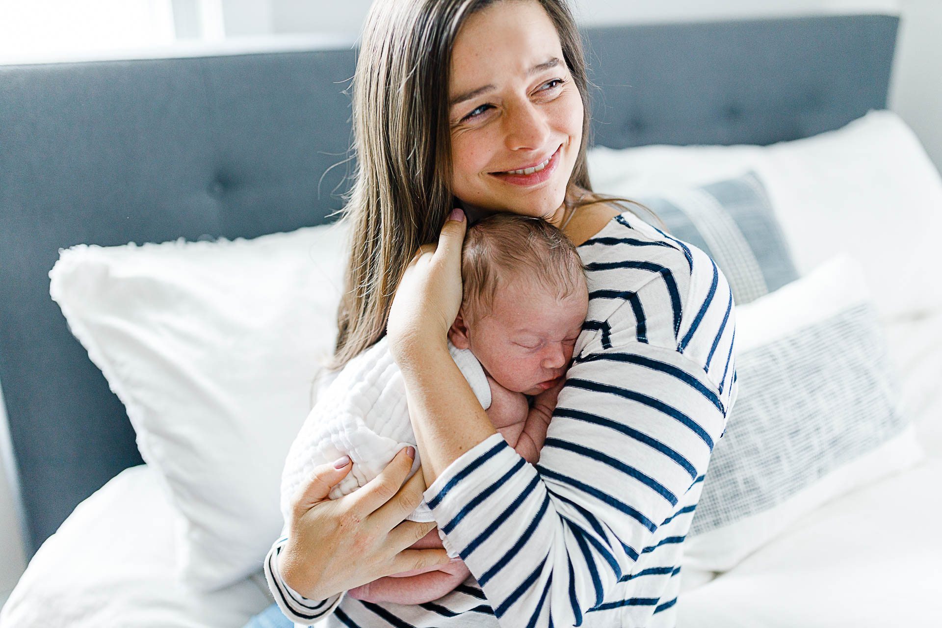 Photo by Scituate newborn photographer Christina Runnals| Mom smiling with newborn boy