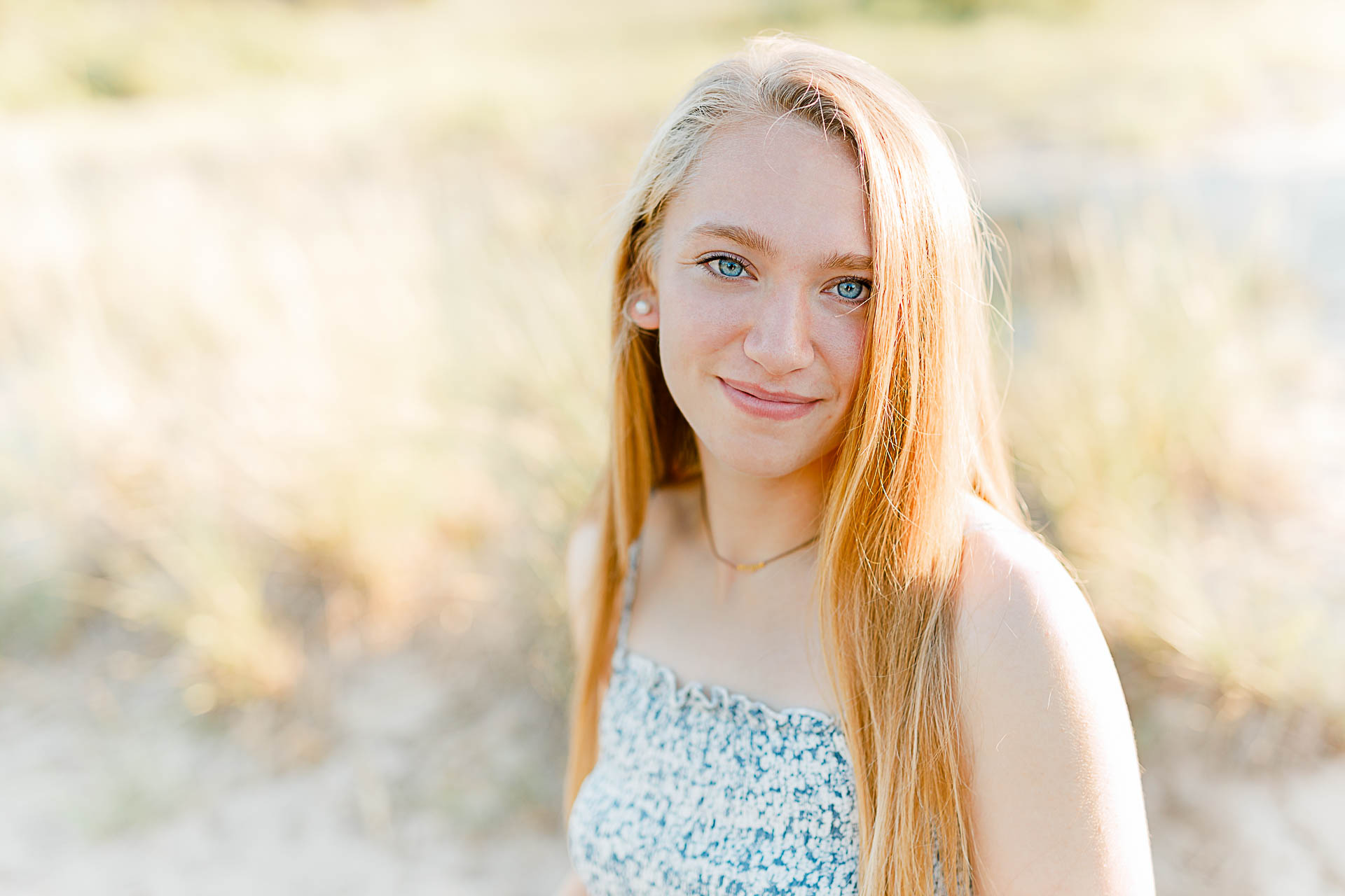 Photo by Plymouth Massachusetts Photographer Christina Runnals | High school senior girl sitting in beach grass