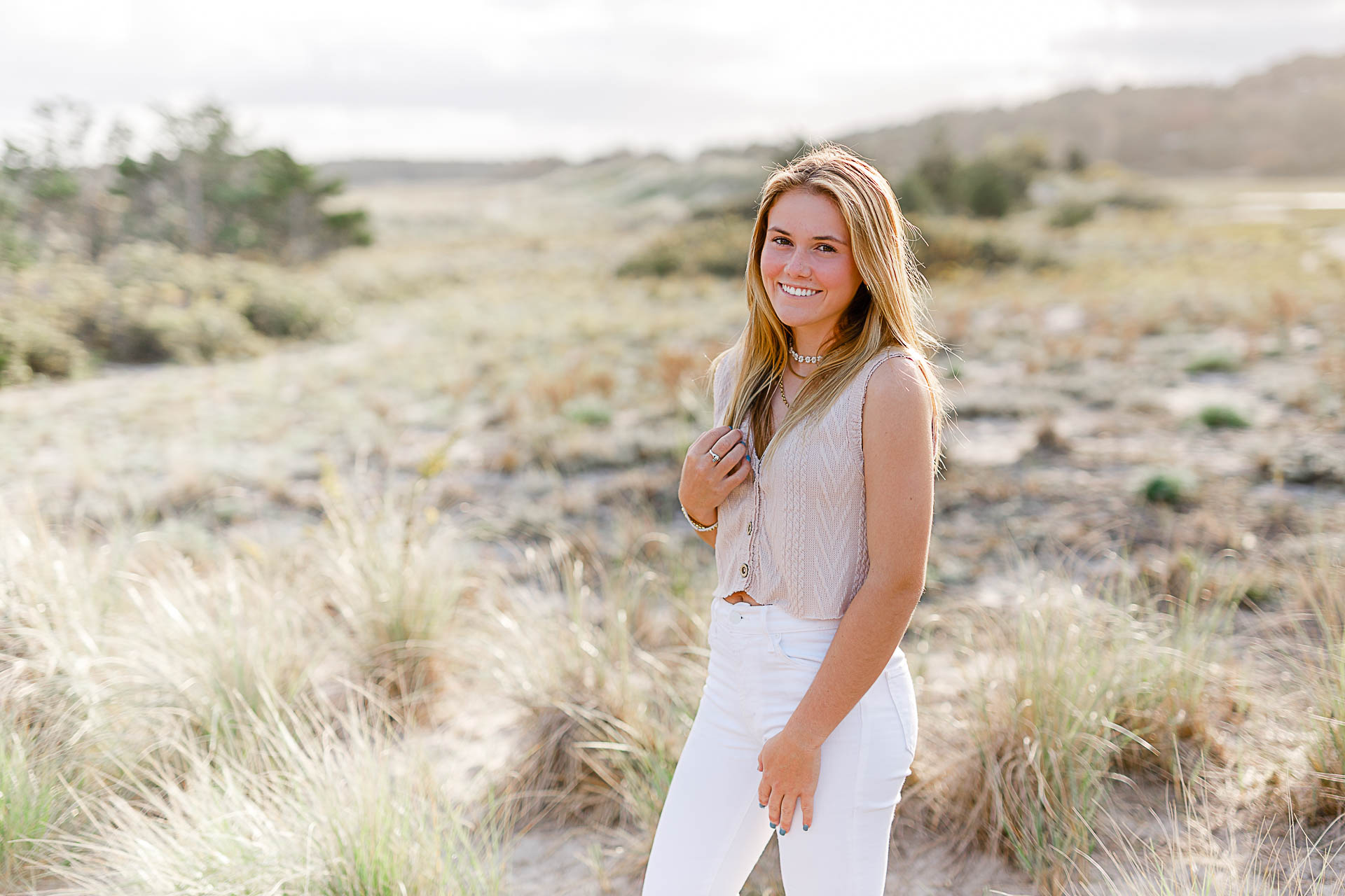 Photo of Caroline's Thayer Academy Senior Pictures by Christina Runnals Photography | Girl smiling in beach grass 