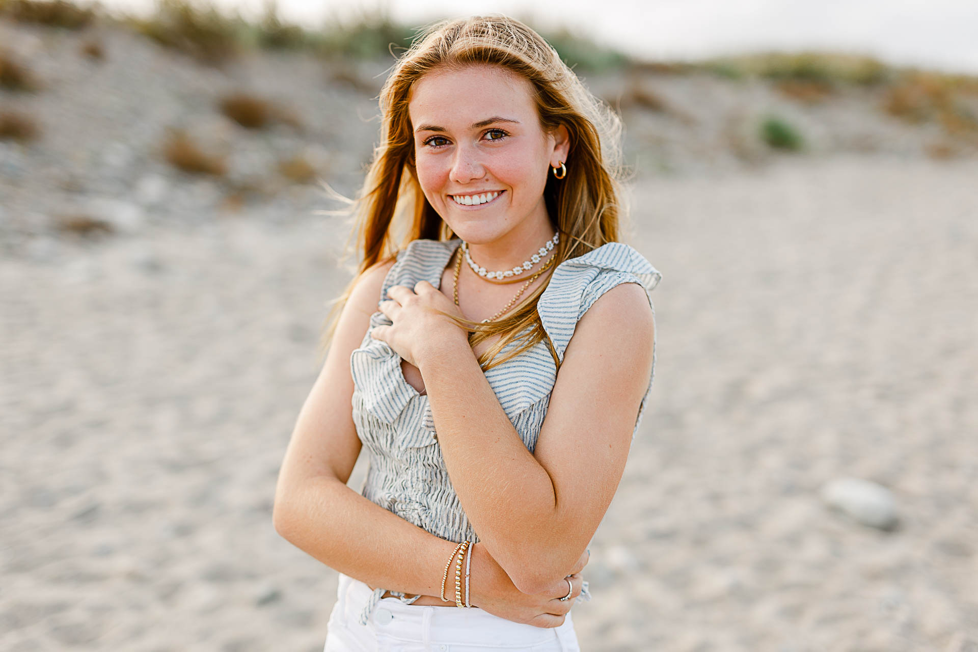 Photo from Caroline's Thayer Academy Senior Pictures by Christina Runnals Photography | High school senior girl standing on the beach smiling