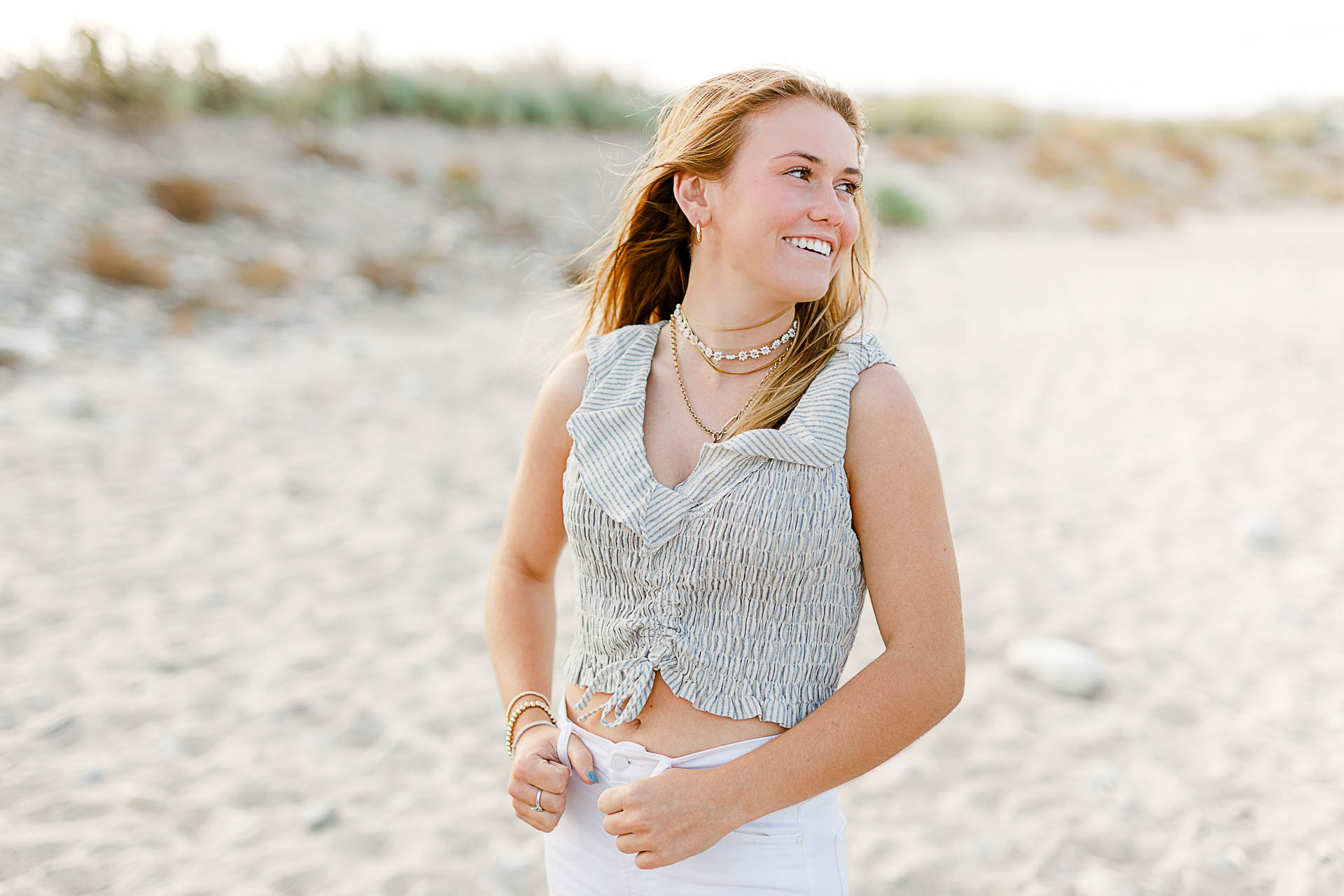 Photo from Caroline's Thayer Academy Senior Pictures by Christina Runnals Photography | High school senior girl standing on the beach smiling
