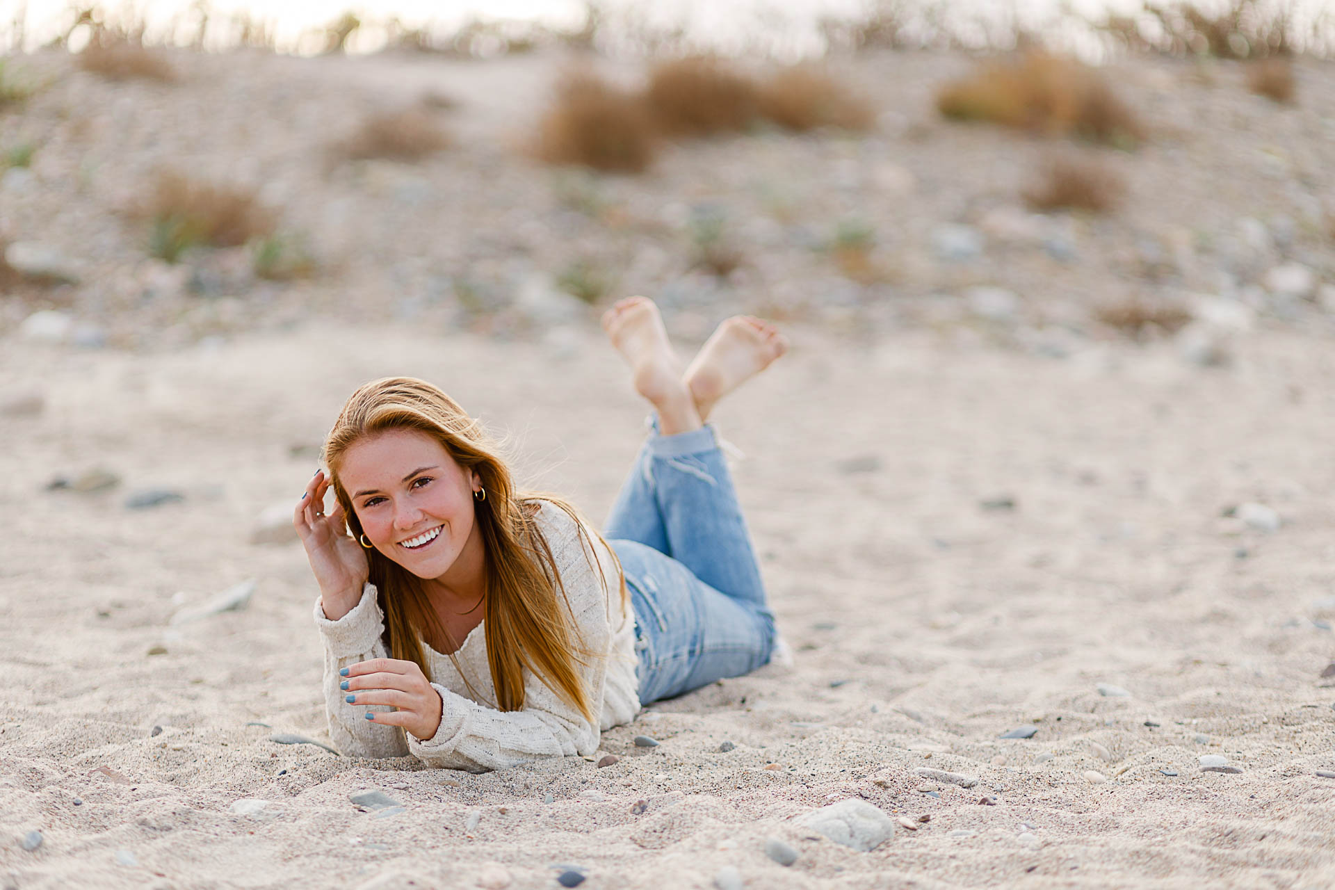 Photo from Caroline's Thayer Academy Senior Pictures by Christina Runnals Photography | High school senior girl laying on the beach laughing