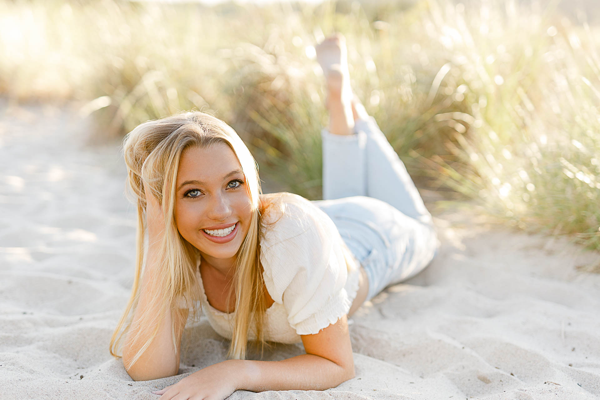 Photo by Scituate Senior Photographer Christina Runnals | High school senior girl laying in the beach grass