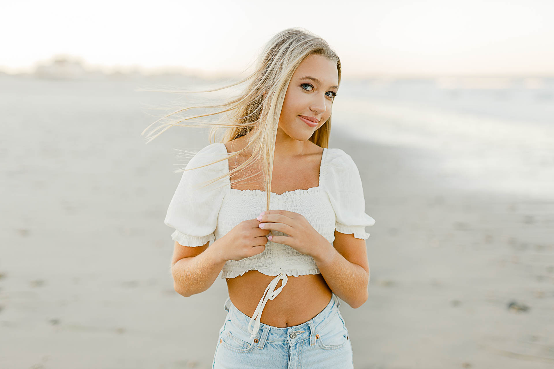 Photo by Scituate Senior Photographer Christina Runnals | High school senior girl smiling subtly at the camera on the beach
