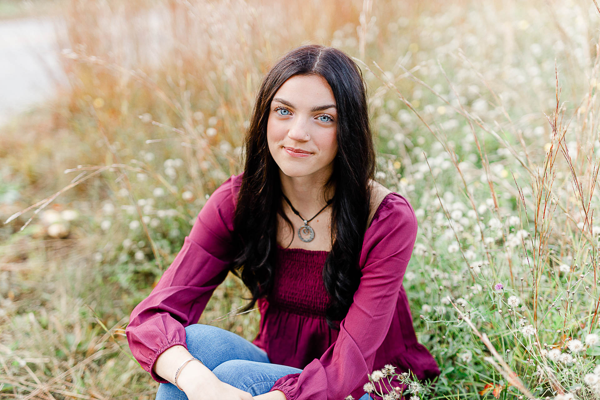 Photo of a high school senior girl in a field by Duxbury senior photographer Christina Runnals