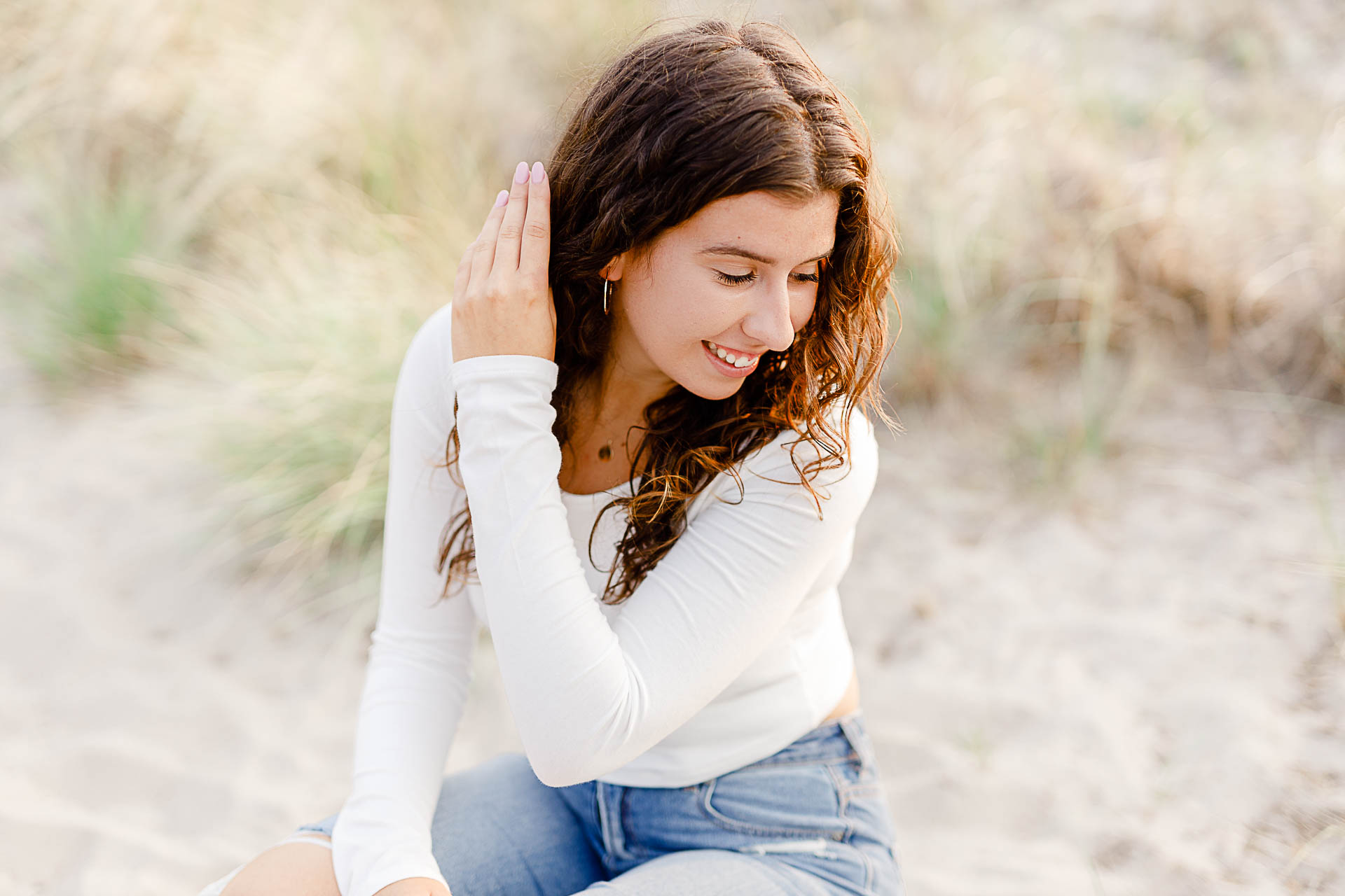 Photo by Hingham Senior Portrait Photographer Christina Runnals | Girl sitting in beach grass
