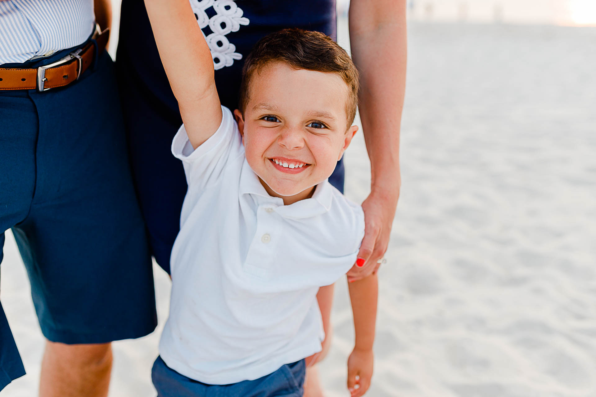 Photo by Cape Cod Family Photographer Christina Runnals | little boy standing with parents on beach