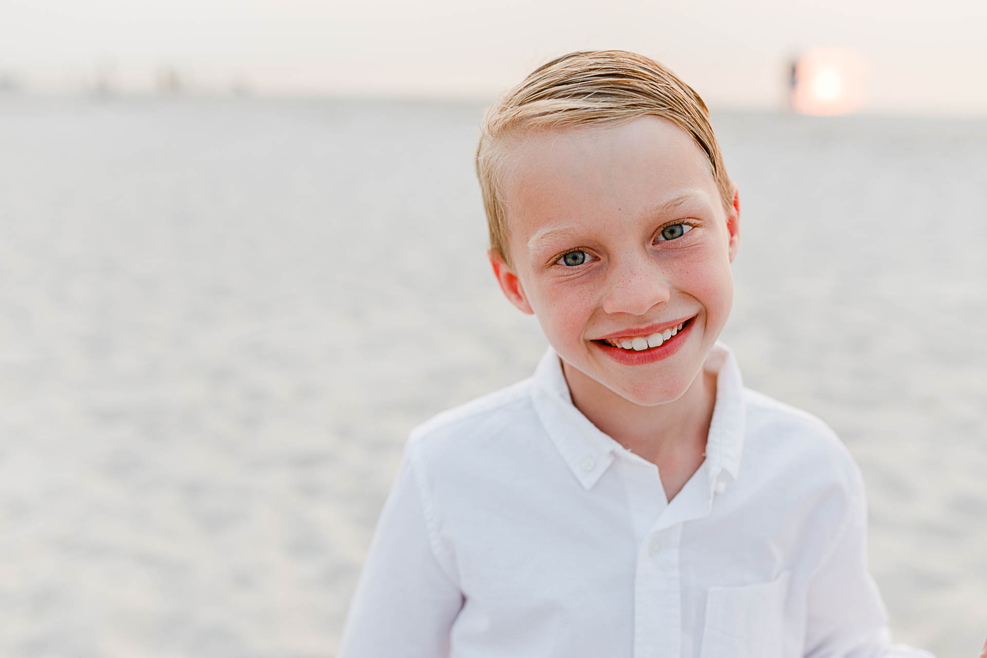 Photo by Cape Cod Family Photographer Christina Runnals | little boy on beach smiling at camera