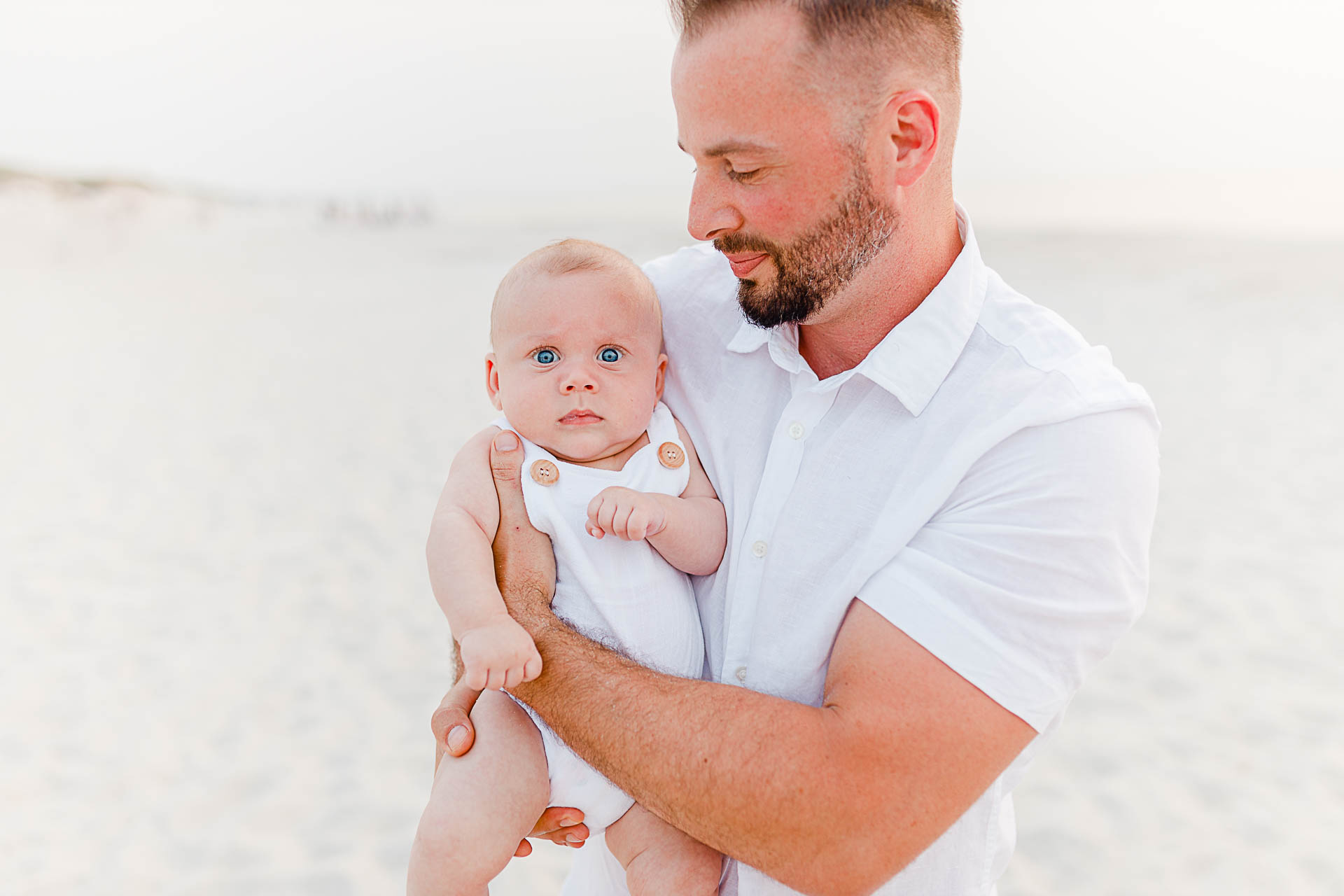 Photo by Cape Cod Family Photographer Christina Runnals | Dad holding baby boy on beach
