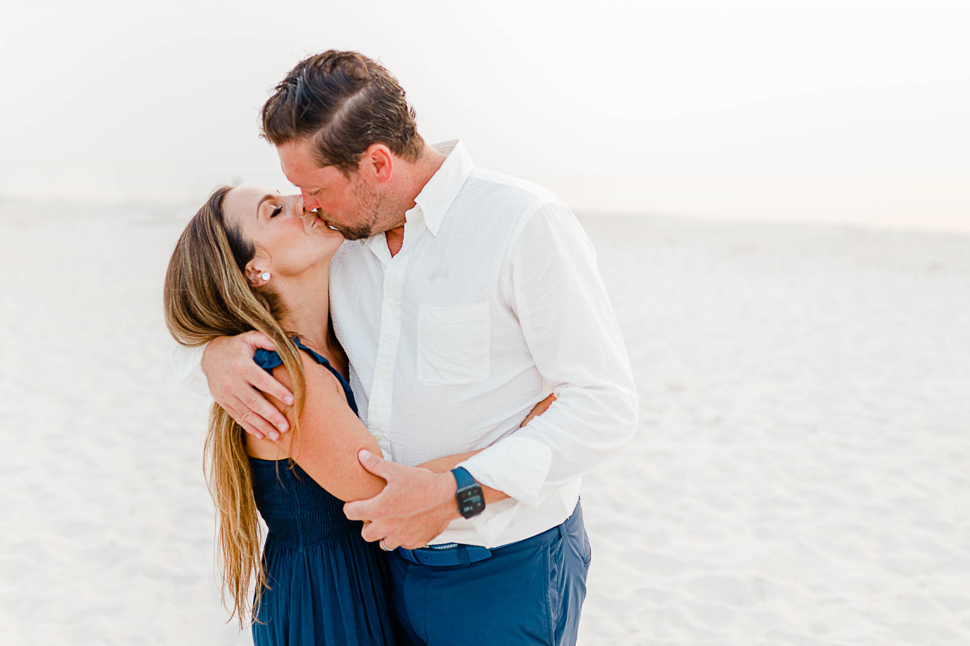 Photo by Cape Cod Family Photographer Christina Runnals | Woman and man kissing on beach