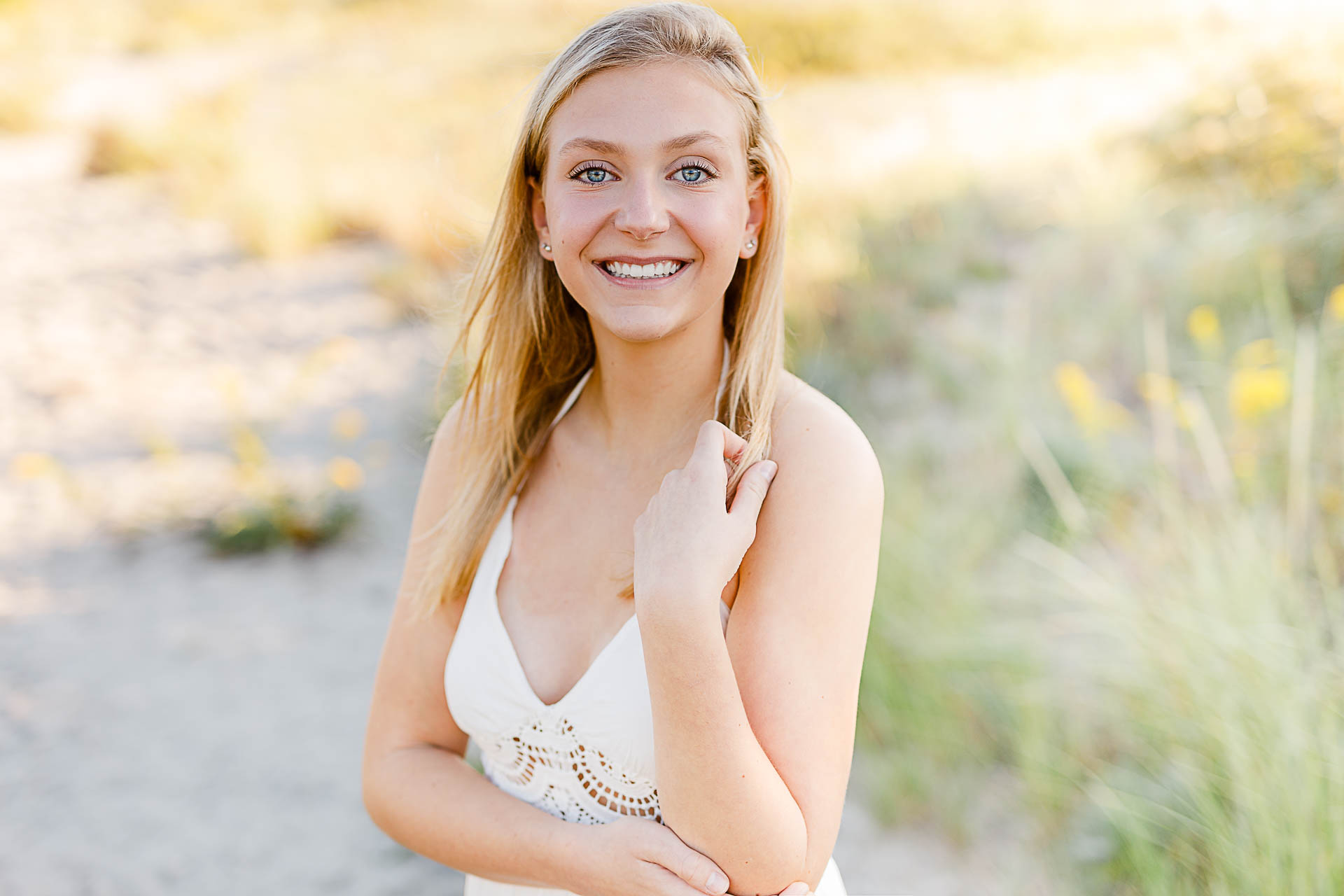 Photo by Christina Runnals Photography who specializes in luxe senior portraits | Girl standing in beach grass