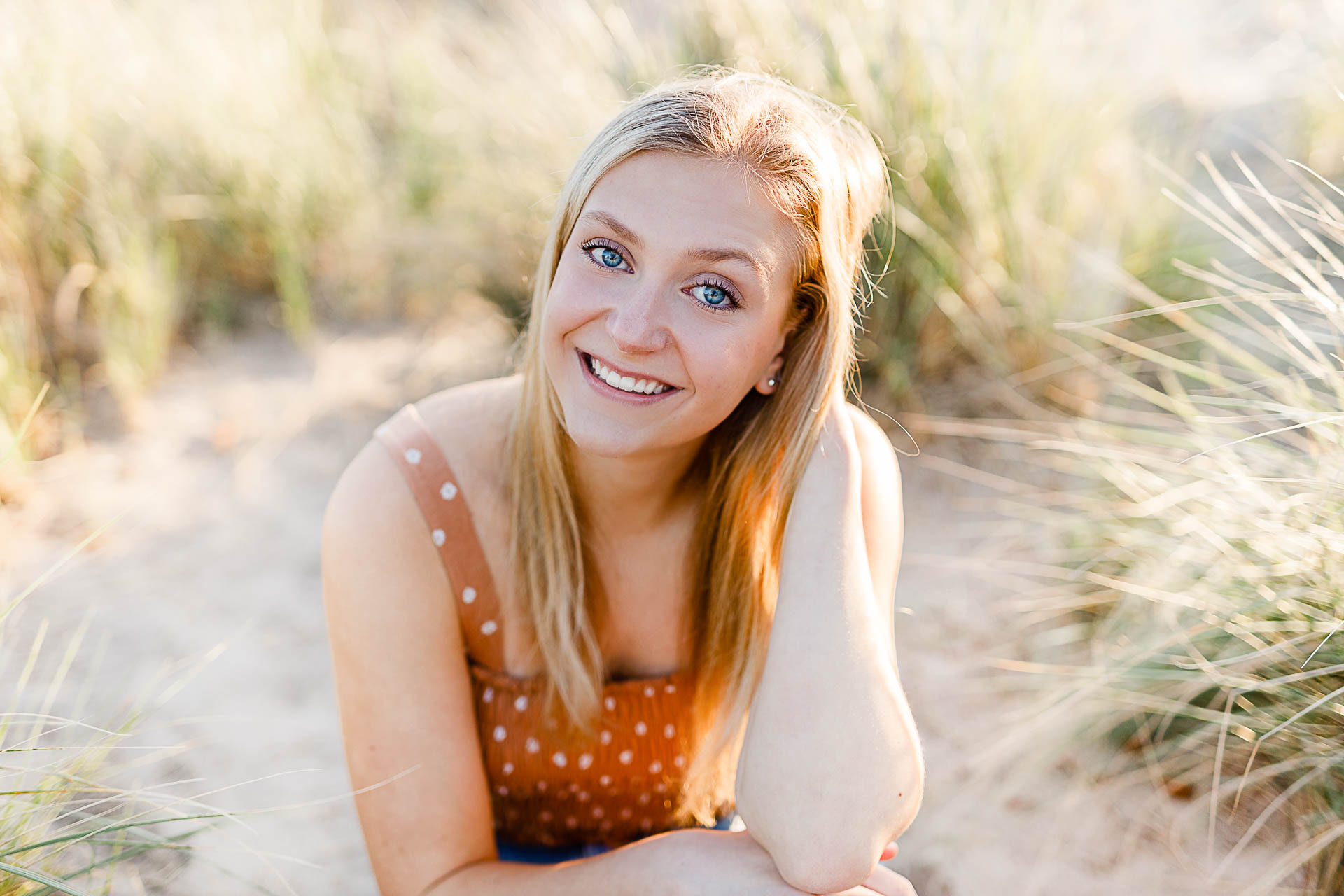 Photo by Christina Runnals Photography who specializes in luxe senior portraits | Girl sitting in beach grass