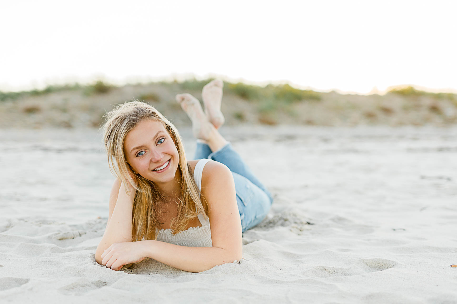 Photo by Christina Runnals Photography who specializes in luxe senior portraits | Girl laying in the sand
