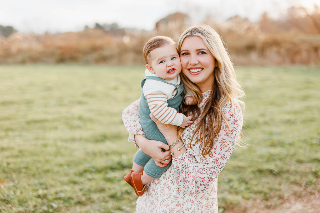 Photo by Hingham Family Photographer Christina Runnals | Mom and son in field smiling