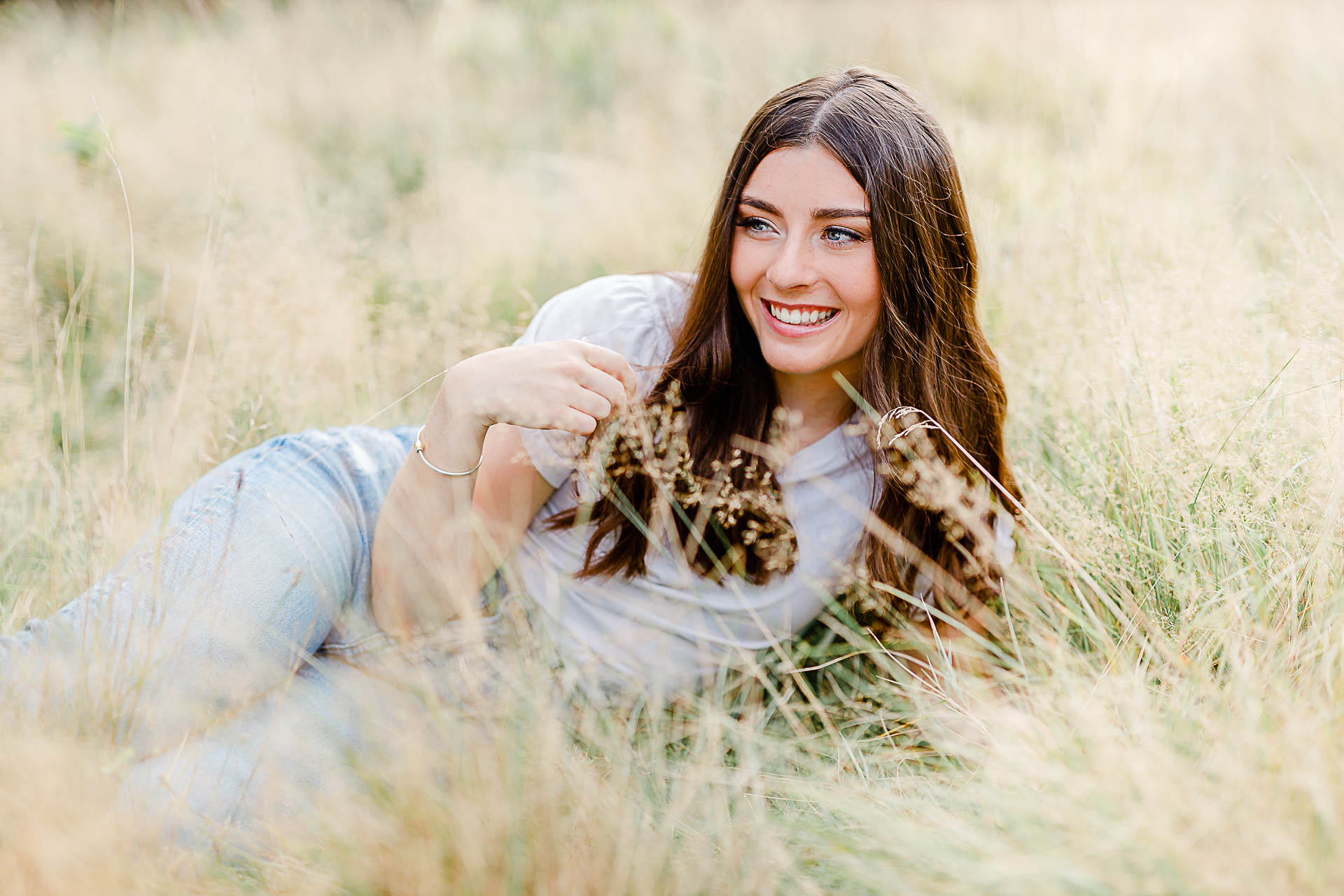 Photo by Duxbury senior portrait photographer Christina Runnals | High school senior girl laying in a field for her senior pictures
