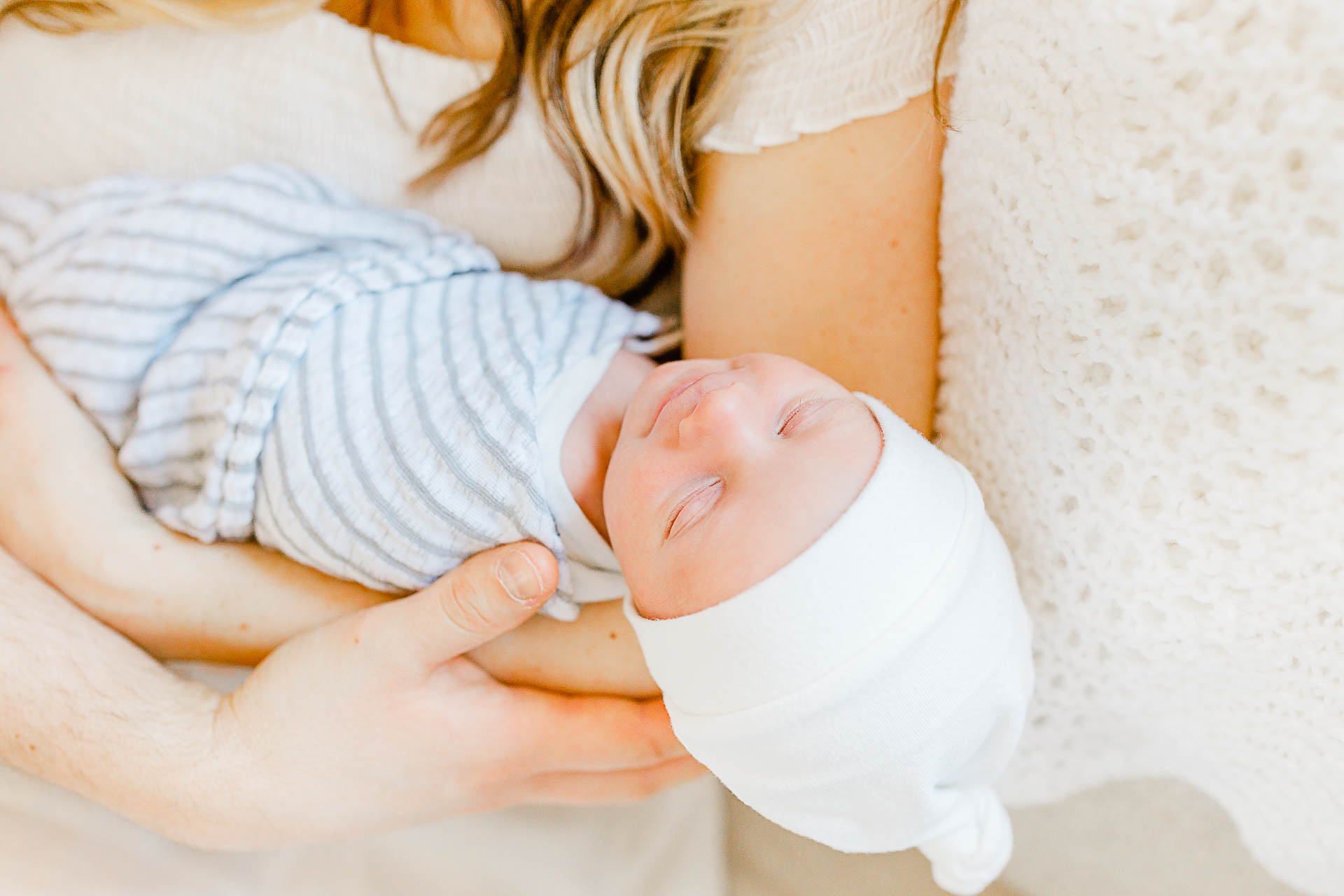 Photo by Boston Newborn Photographer Christina Runnals | Couple holding their newborn baby boy