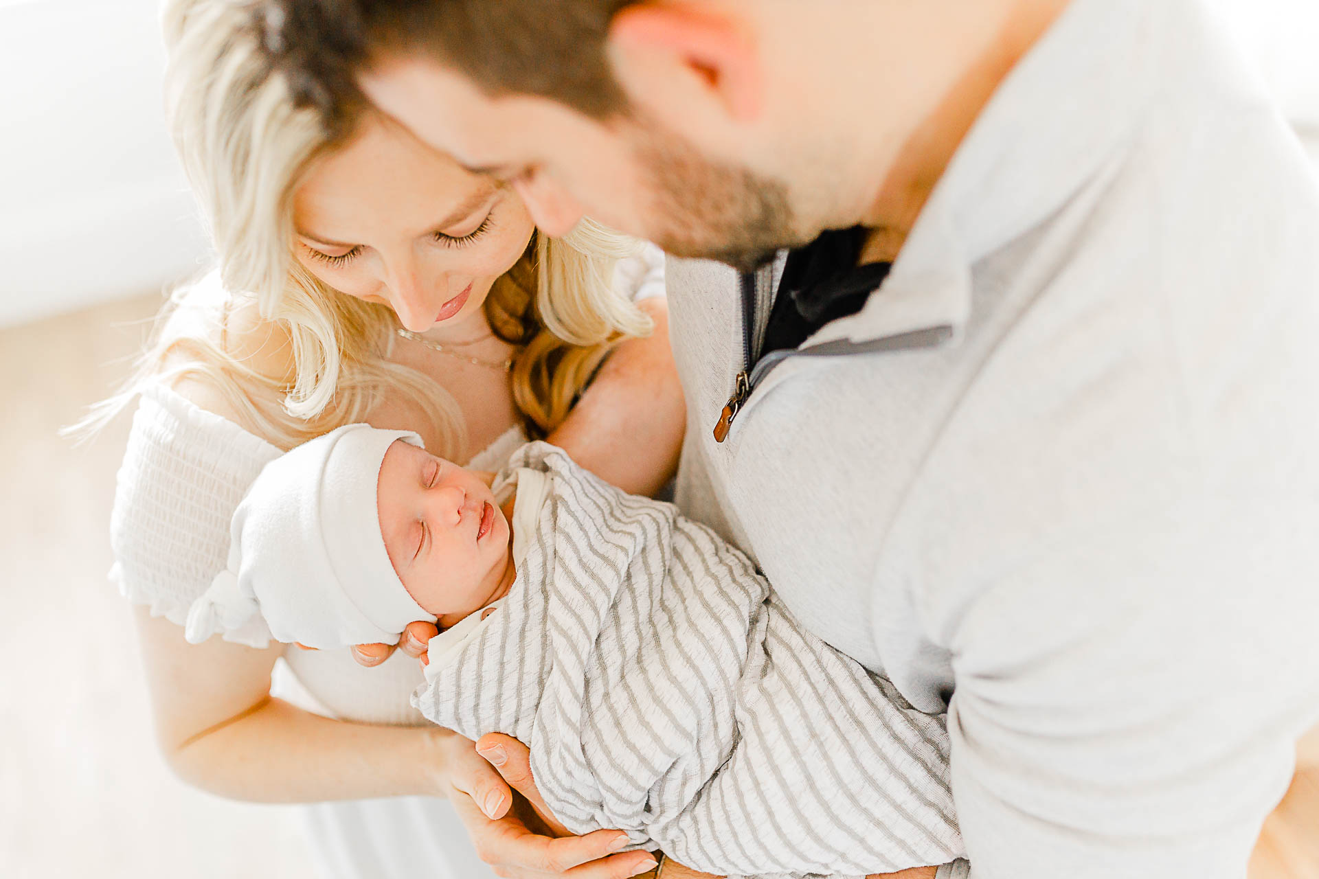 Photo by Boston Newborn Photographer Christina Runnals |  Couple holding their newborn baby boy