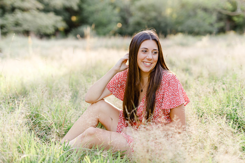 Photo by Norwell Senior Portrait Photographer Christina Runnals | High school girl sitting in a golden field 