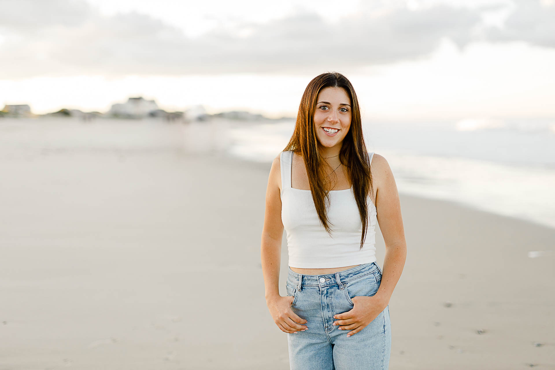 Photo by Norwell Senior Portrait Photographer Christina Runnals | High school girl standing on the beach and smiling