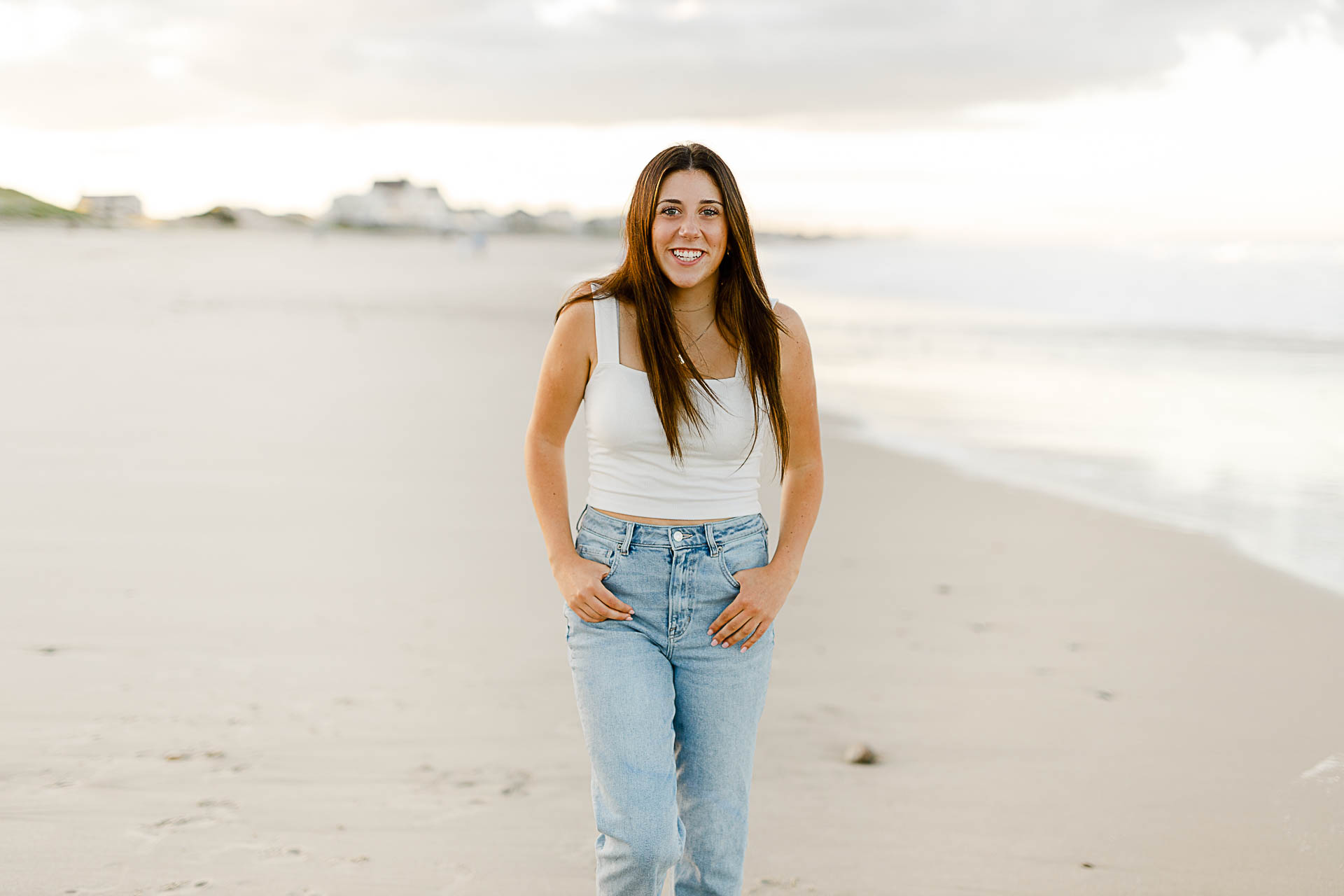 Photo by Norwell Senior Portrait Photographer Christina Runnals | High school girl walking on the beach and laughing