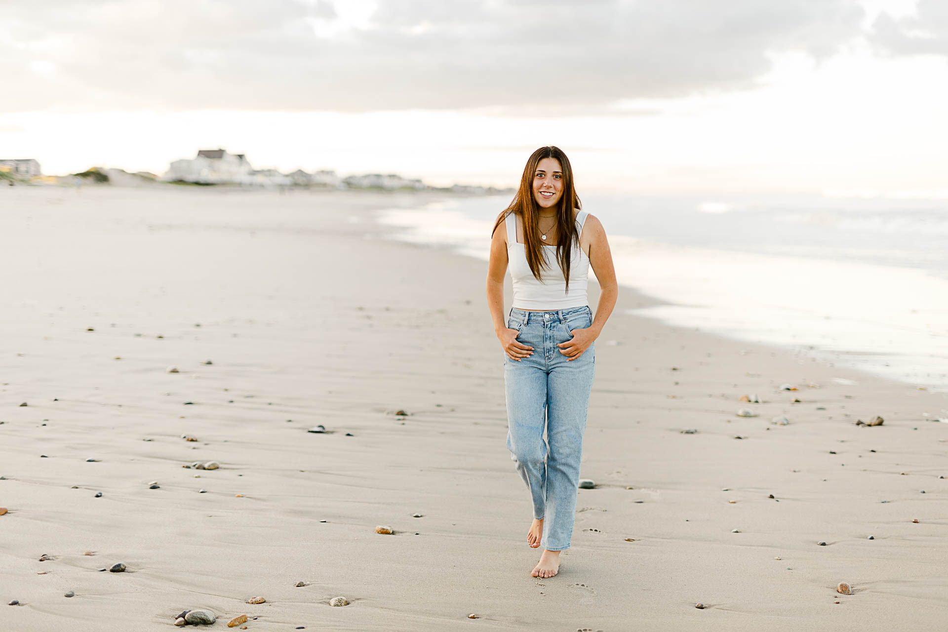 Photo by Norwell Senior Portrait Photographer Christina Runnals | High school girl walking on the beach and laughing