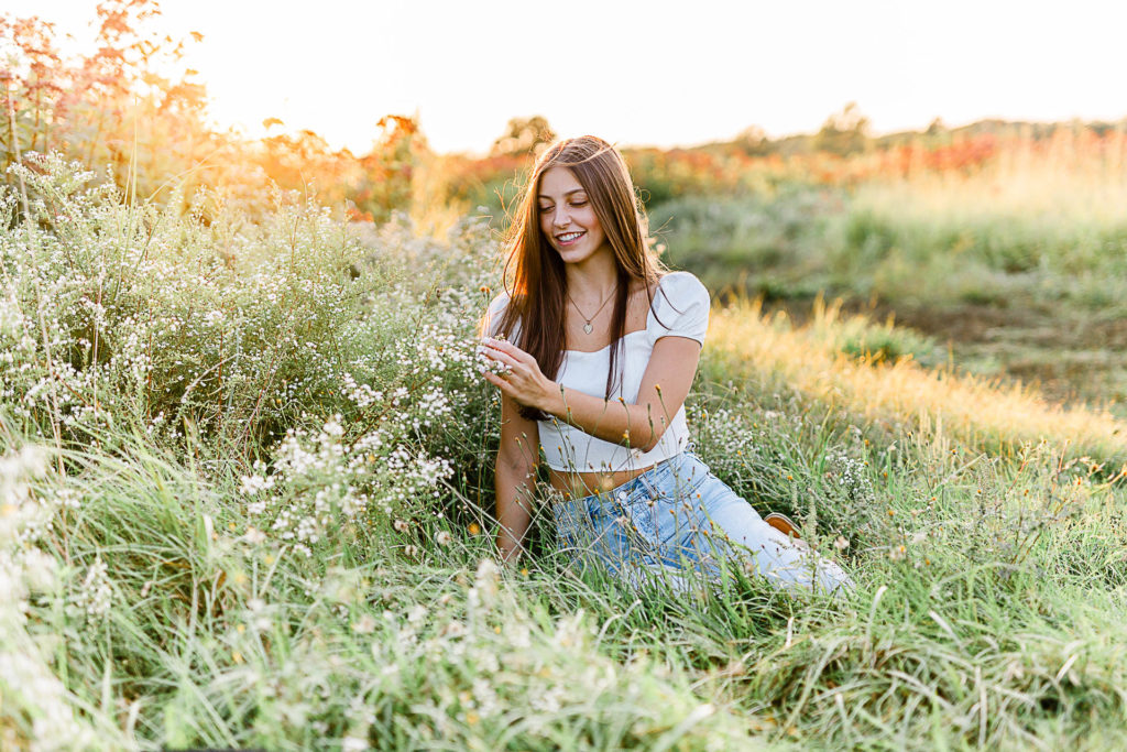 Photo by Scituate Senior Portrait Photographer Christina Runnals | High school senior girl sitting in a flower field
