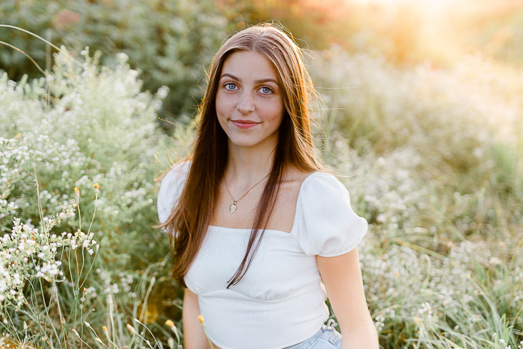 Photo by Scituate Senior Portrait Photographer Christina Runnals | High school senior girl sitting in a flower field