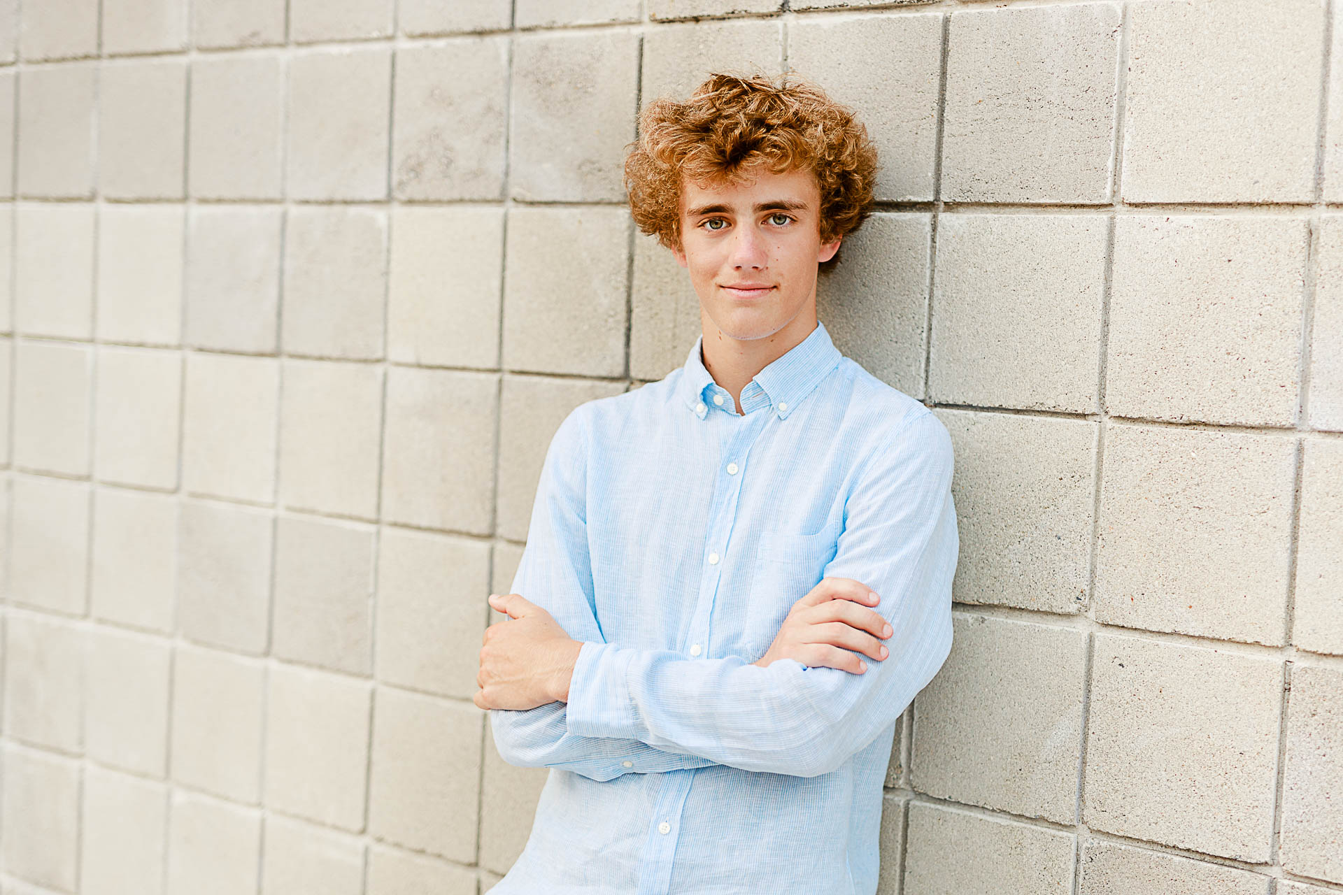 Photo by Scituate Senior Portrait Photographer Christina Runnals | High school senior boy leaning against a wall