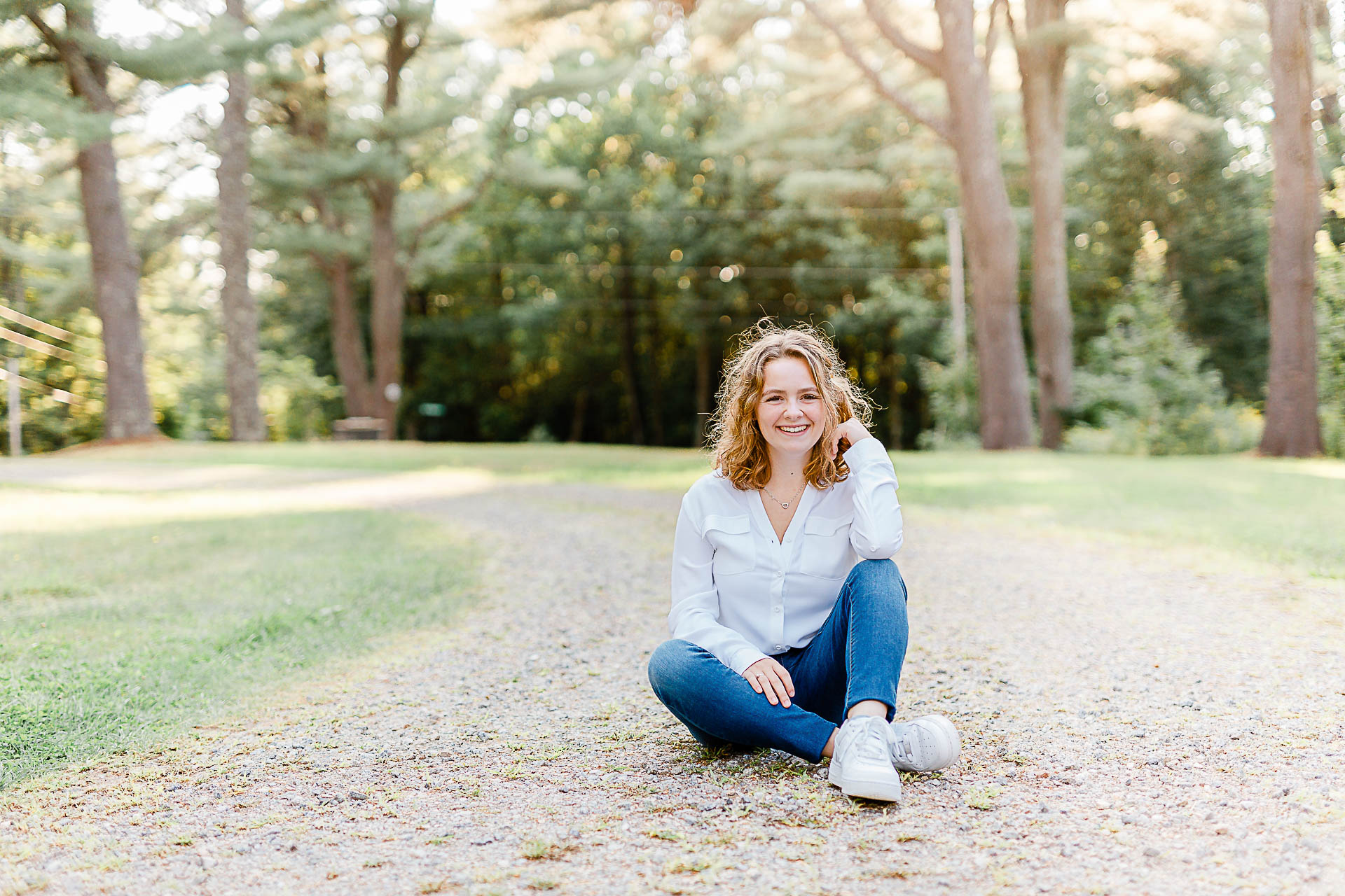 Photo by Scituate Senior Portrait Photographer Christina Runnals | High school senior girl sitting on a gravel road in a forest